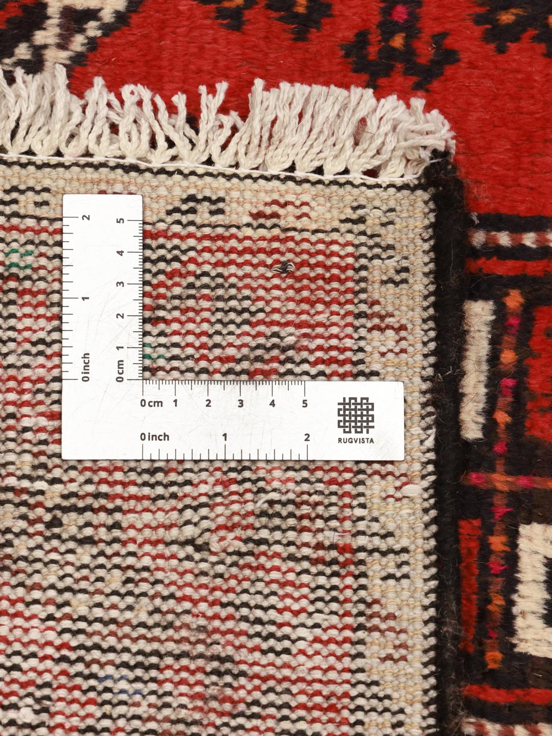 A hand-knotted Hamadan runner from the Middle East featuring a red field and traditional geometric motifs.
