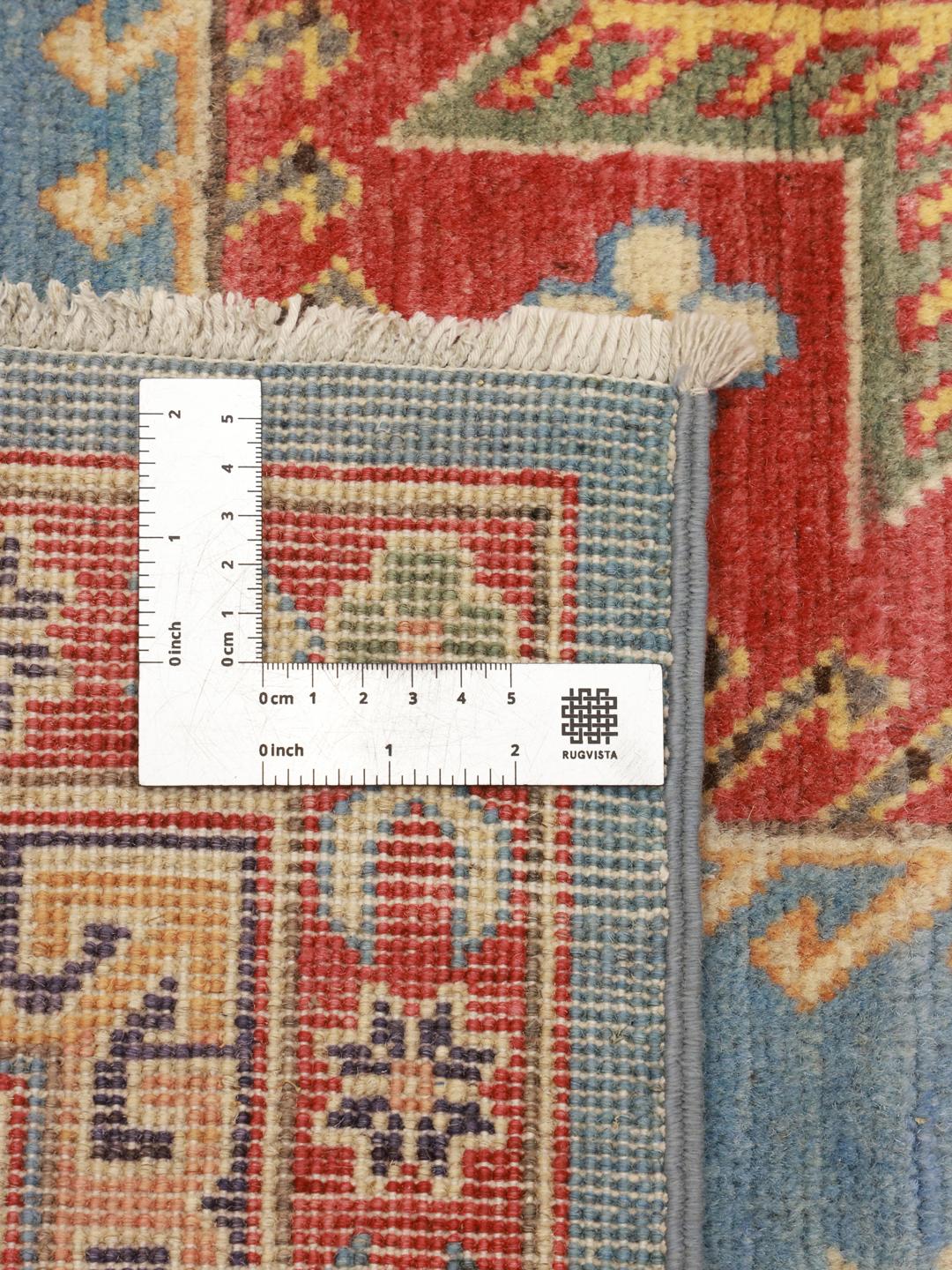 Hand-knotted Kazak rug from Afghanistan with a blue field and geometric patterns.