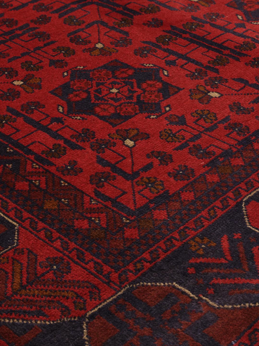 Hand-knotted Afghan Khal Mohammadi rug in rich red tones featuring traditional geometric motifs.