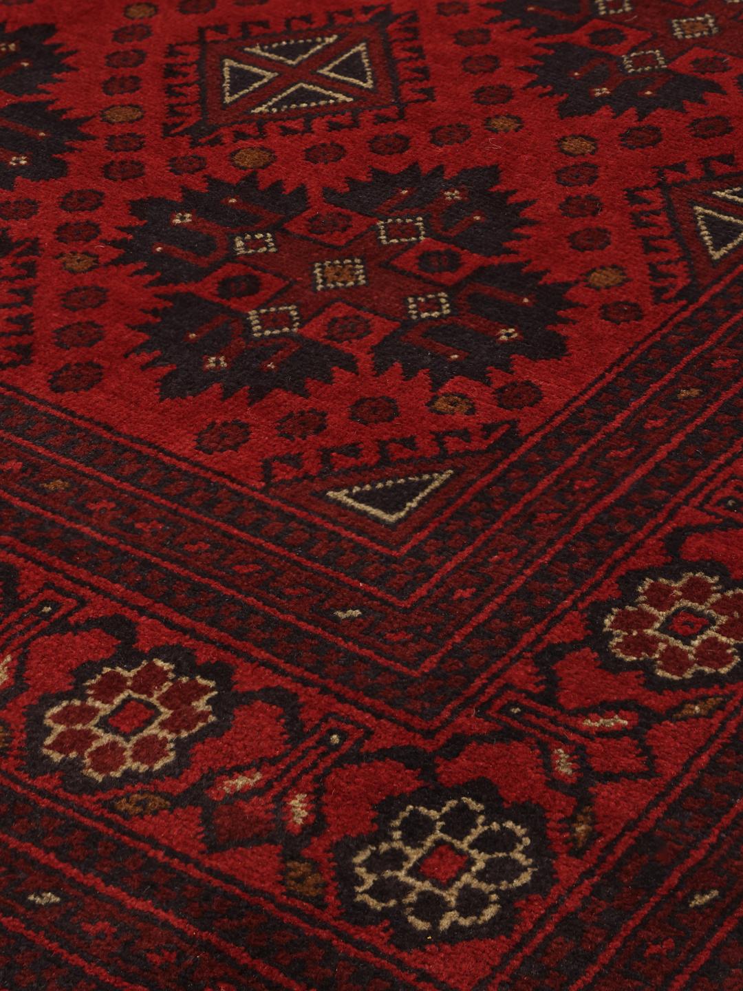 Hand-knotted Afghan Khal Mohammadi rug in dark-red with traditional geometric motifs.