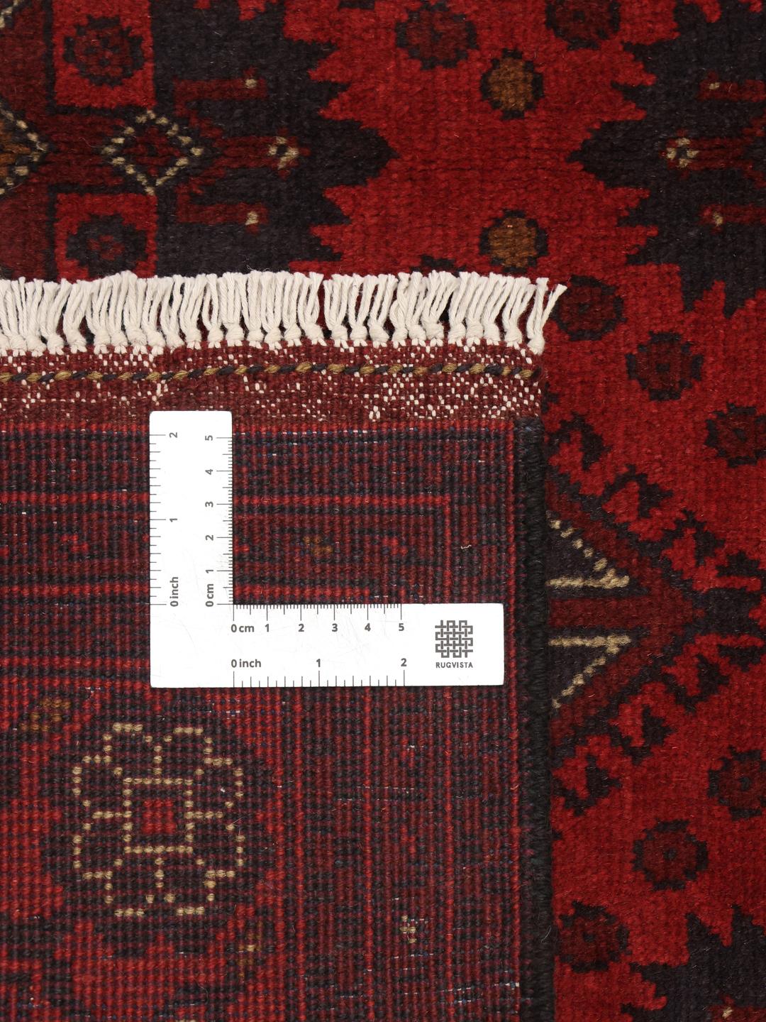 Hand-knotted Afghan Khal Mohammadi rug in dark-red with traditional geometric motifs.