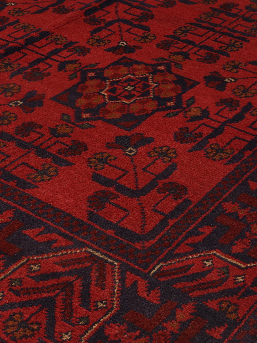 Hand-knotted Afghan Khal Mohammadi rug in deep red with geometric patterns