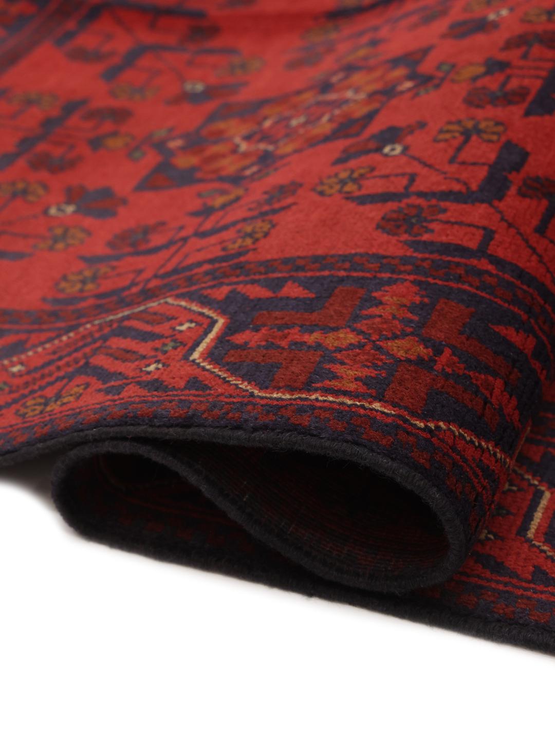 Hand-knotted Afghan Khal Mohammadi rug in deep red with geometric patterns