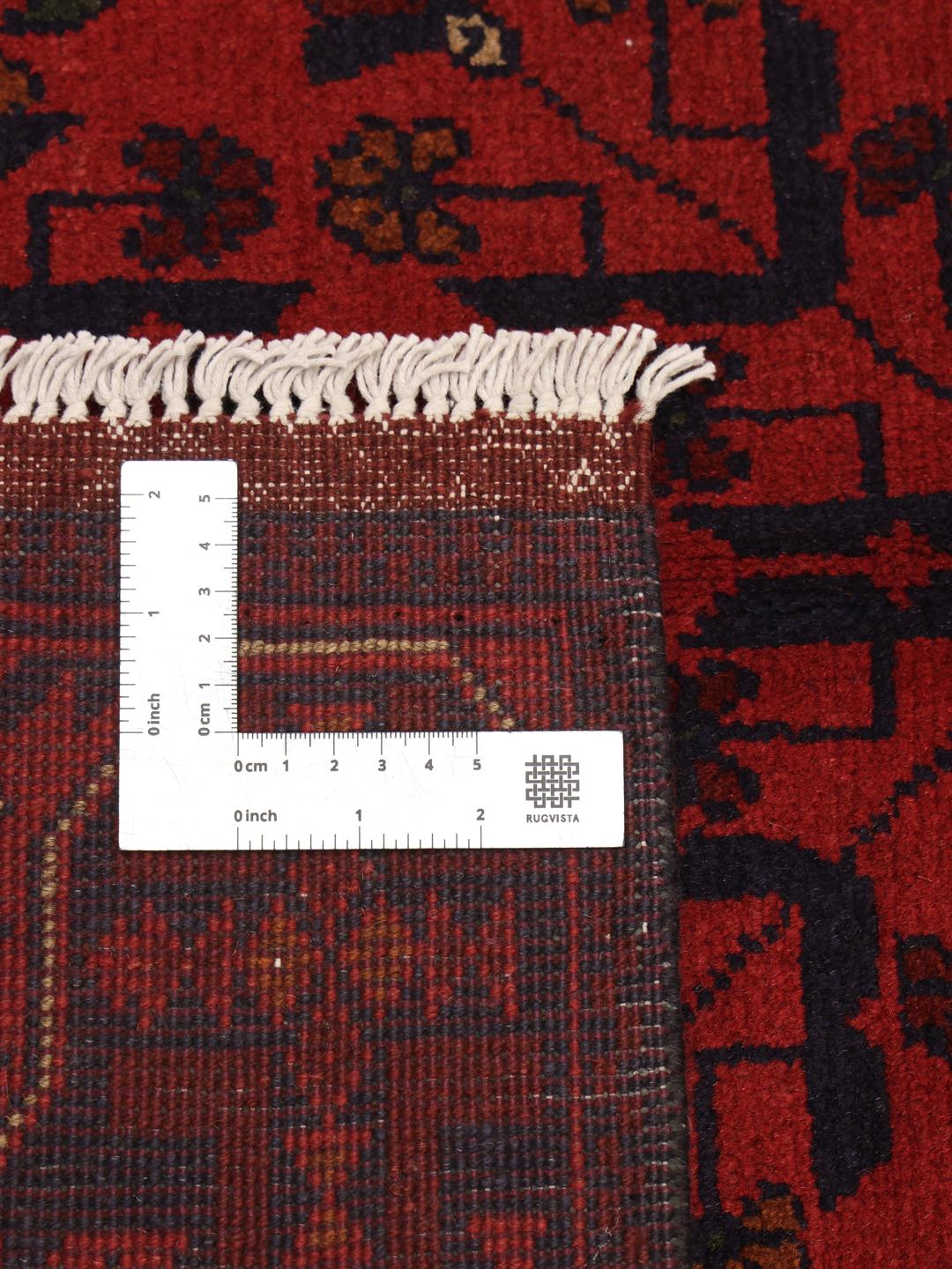 Hand-knotted Afghan Khal Mohammadi rug in deep red with geometric patterns