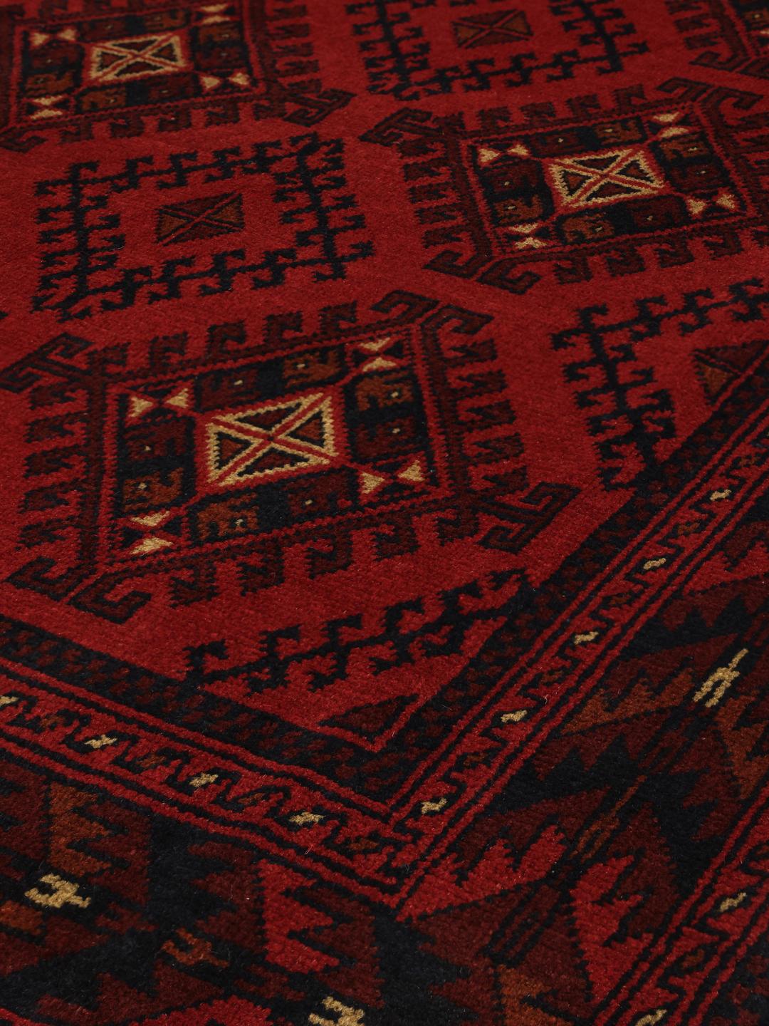 Hand-knotted Afghan Khal Mohammadi rug in dark-red tones.