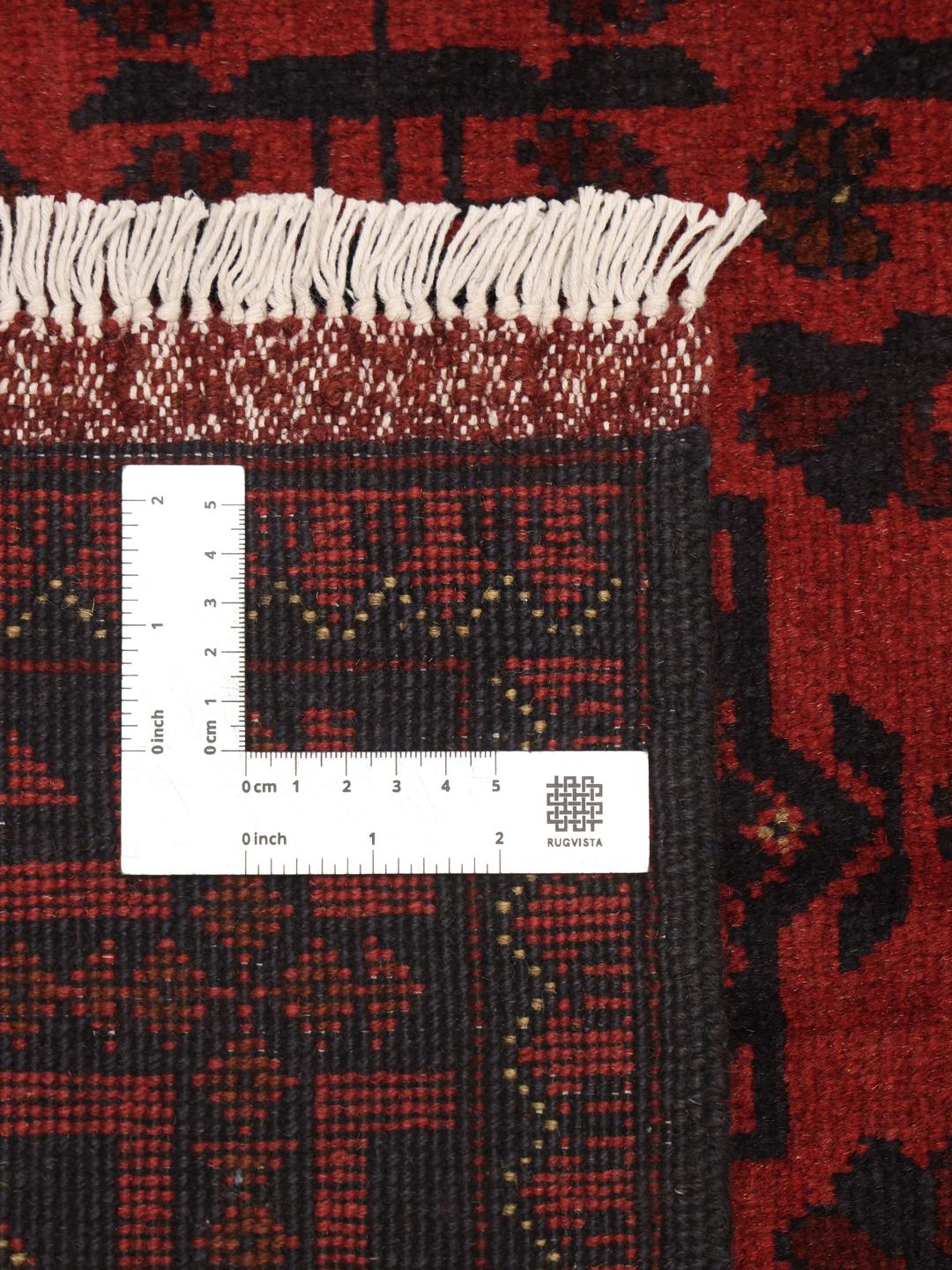 Hand-knotted Afghan Khal Mohammadi rug in deep dark-red with geometric patterns