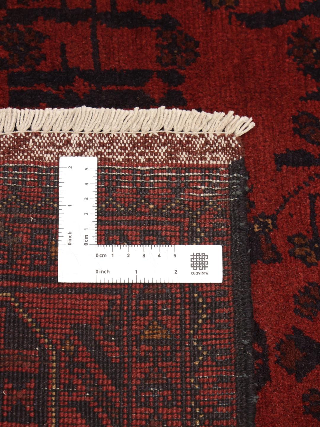 Hand-knotted Afghan Khal Mohammadi rug in deep red with geometric motifs