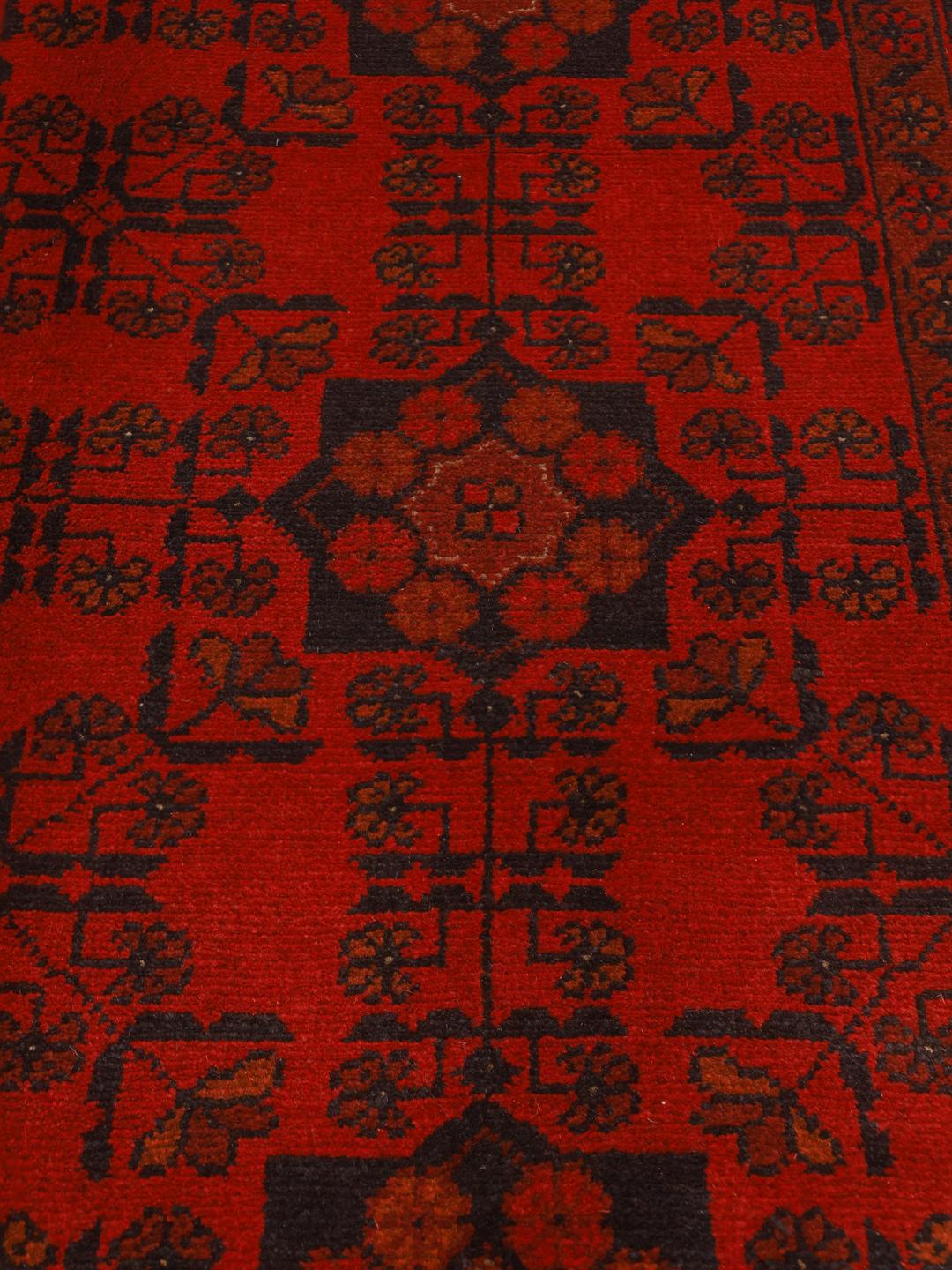 Hand-knotted Afghan Khal Mohammadi rug with traditional dark red and black motifs.