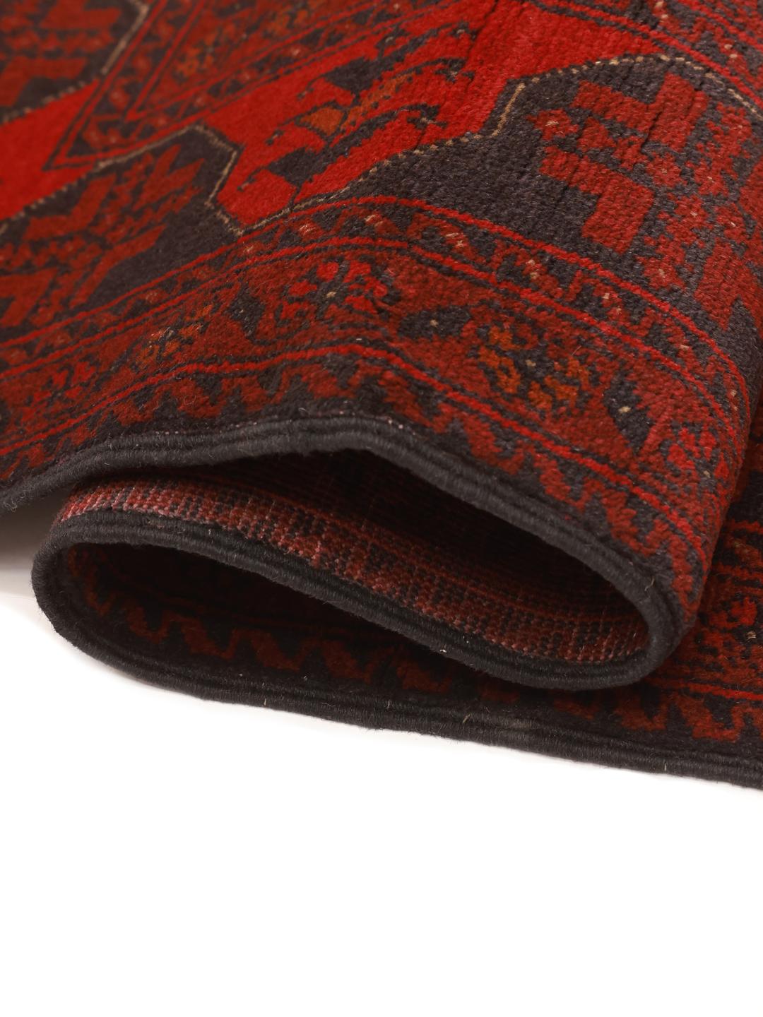 Hand-knotted Afghan Khal Mohammadi rug with traditional dark red and black motifs.