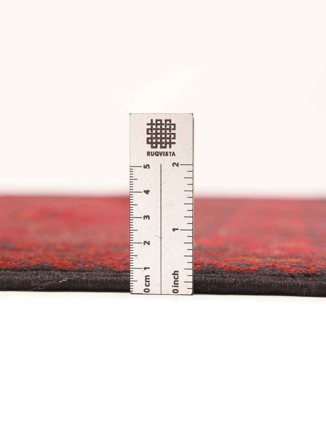 Hand-knotted Afghan Khal Mohammadi rug with traditional dark red and black motifs.