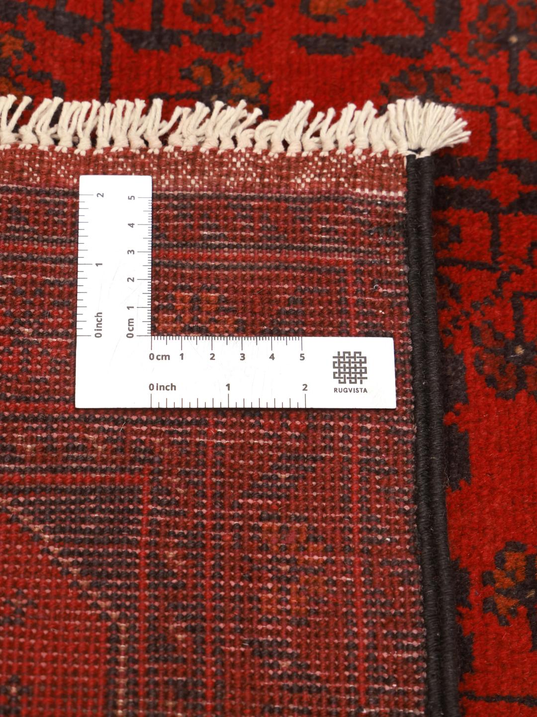 Hand-knotted Afghan Khal Mohammadi rug with traditional dark red and black motifs.
