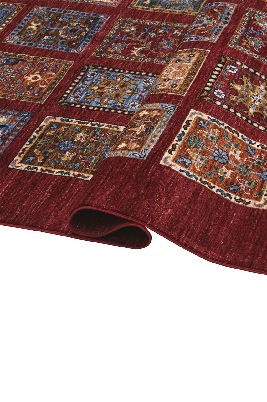 Hand-knotted Middle Eastern rug with a red field and decorative multi-coloured geometric panels