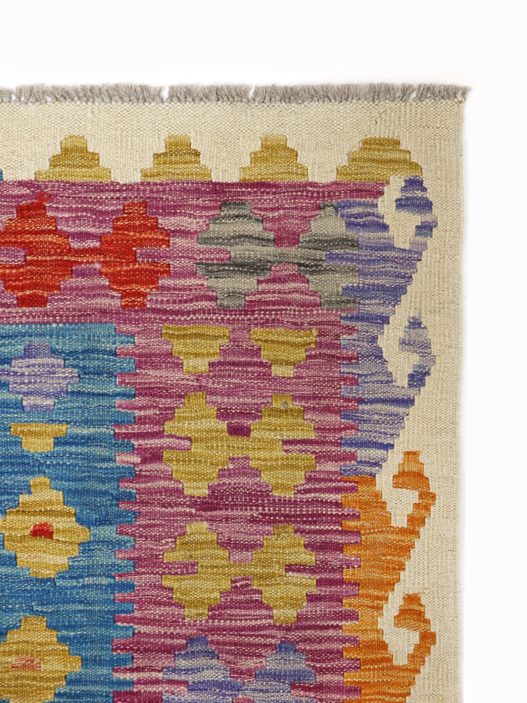 Hand-woven Afghan Kelim rug featuring a colourful geometric diamond pattern