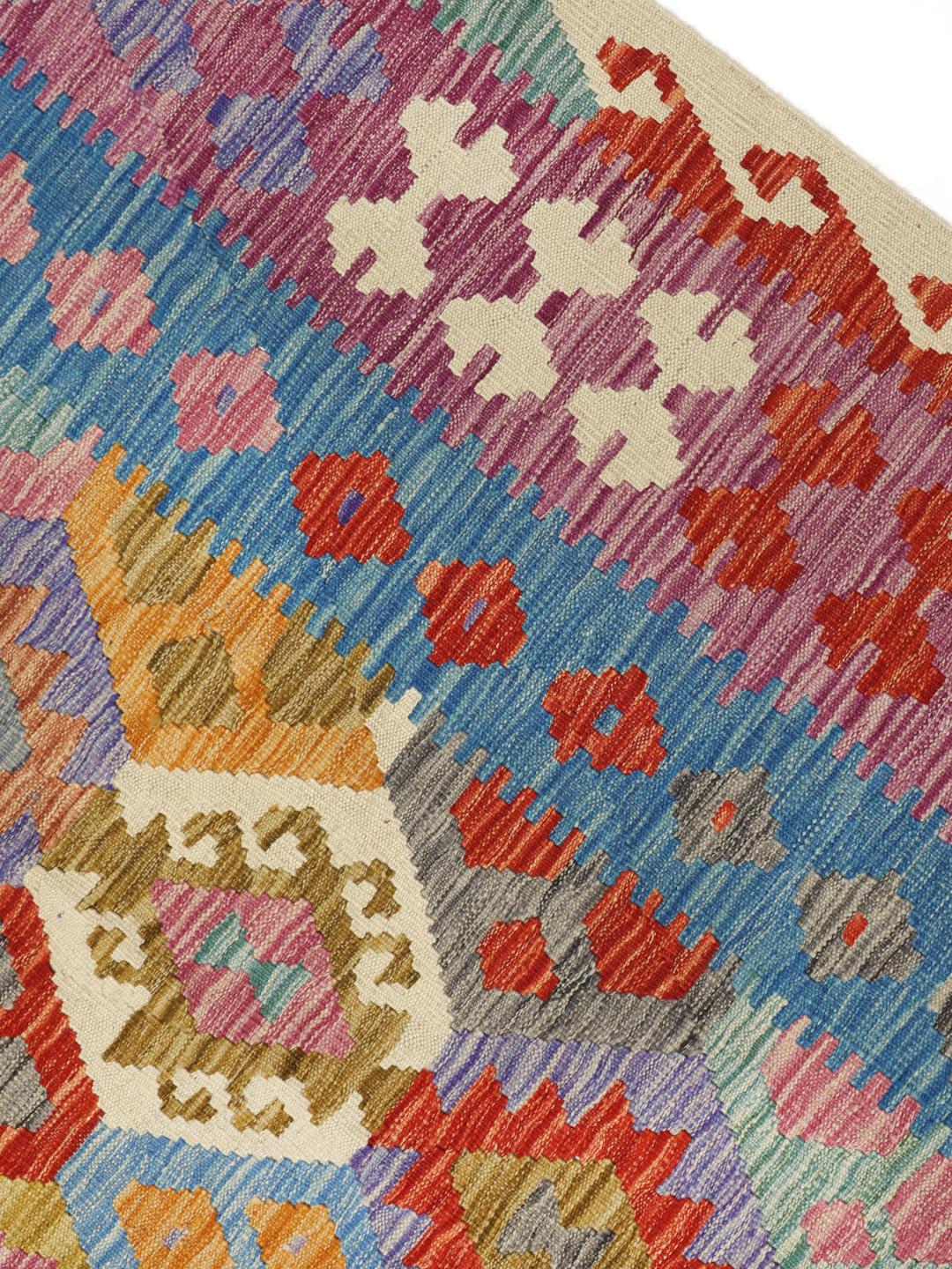 Hand-woven Afghan Kelim rug featuring a colourful geometric diamond pattern