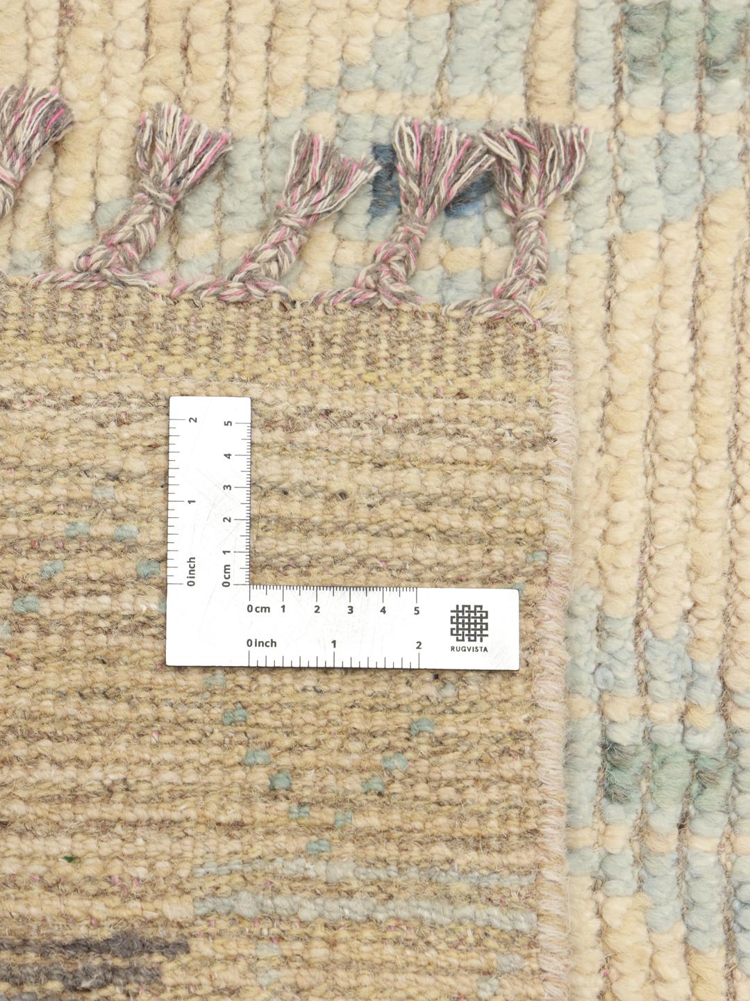Hand-knotted Afghan rug with a beige base and colourful geometric patterns