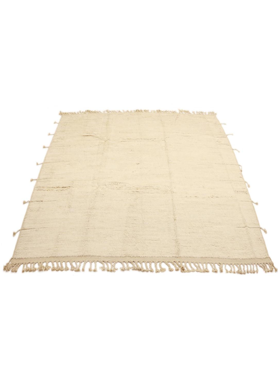 A neutral, hand-knotted beige rug from Afghanistan with an organic, minimalist design.