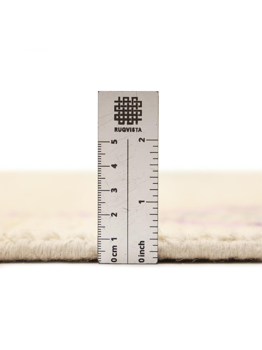 Hand-knotted Berber-inspired rug from Afghanistan with a beige field and multicolor diamond motifs