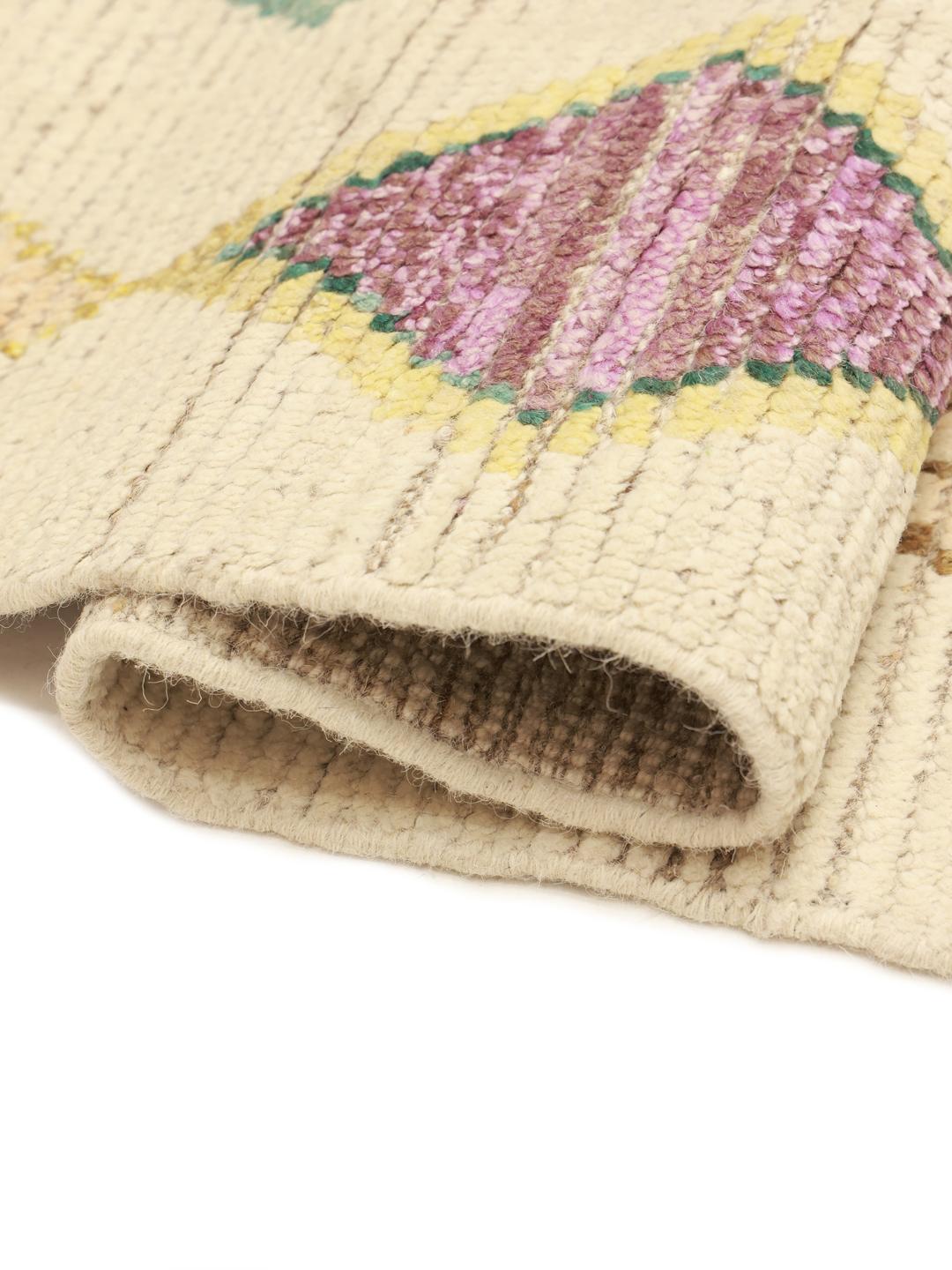 Hand-knotted Afghan rug with colourful diamond motifs on a beige background