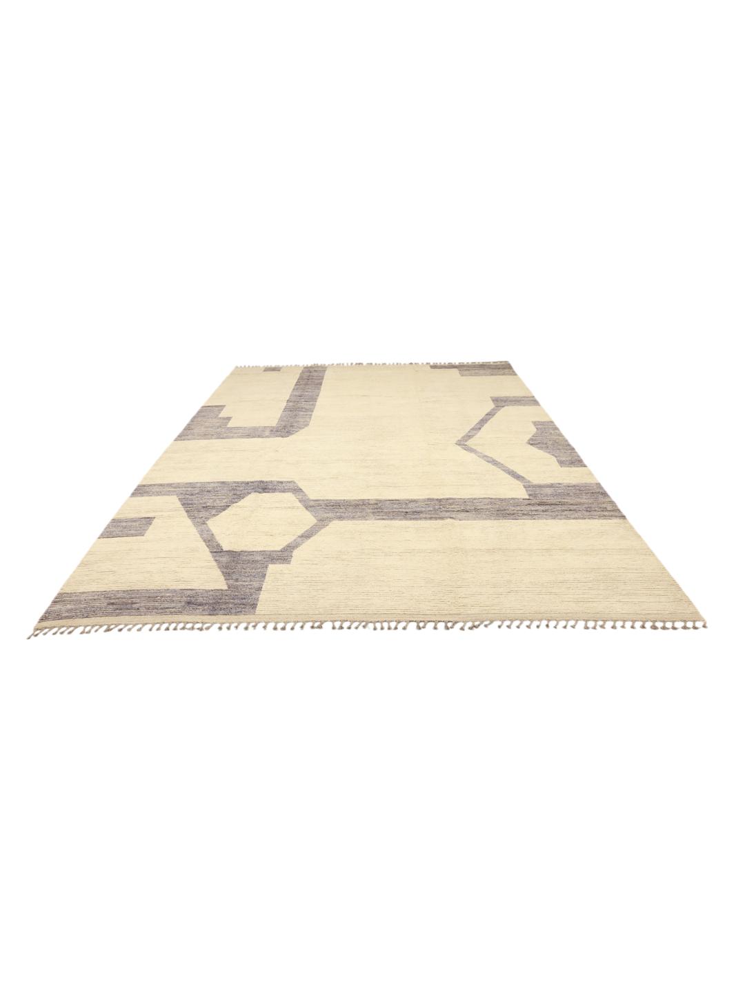A large hand-knotted Afghan rug featuring a geometric pattern in beige and grey