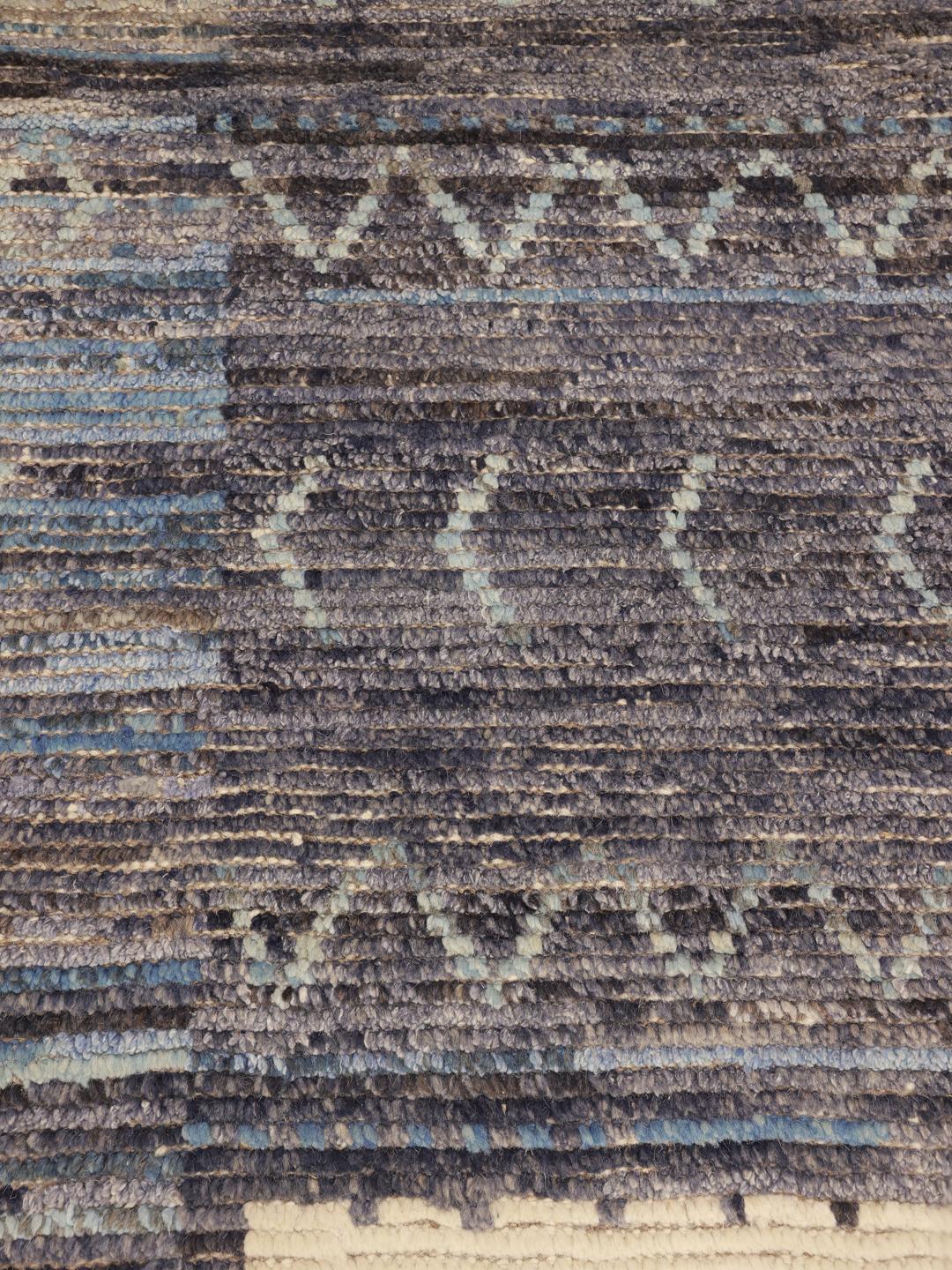 Hand-knotted Afghan rug with neutral tones and artistic motifs