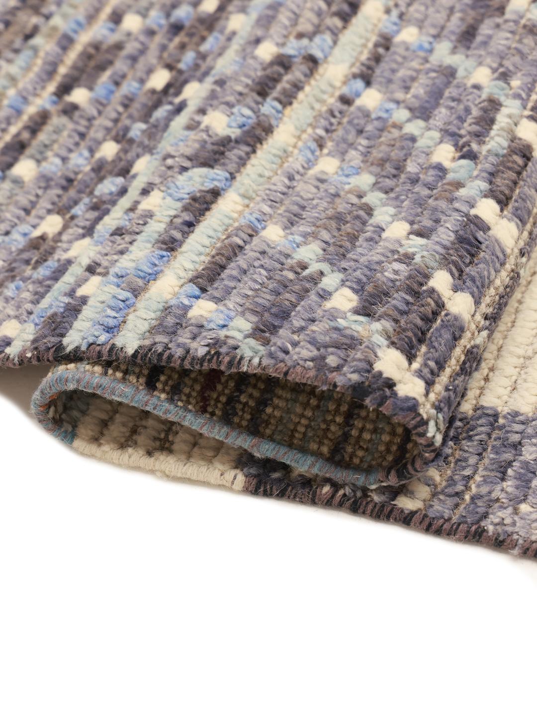 Hand-knotted Afghan rug with neutral tones and artistic motifs