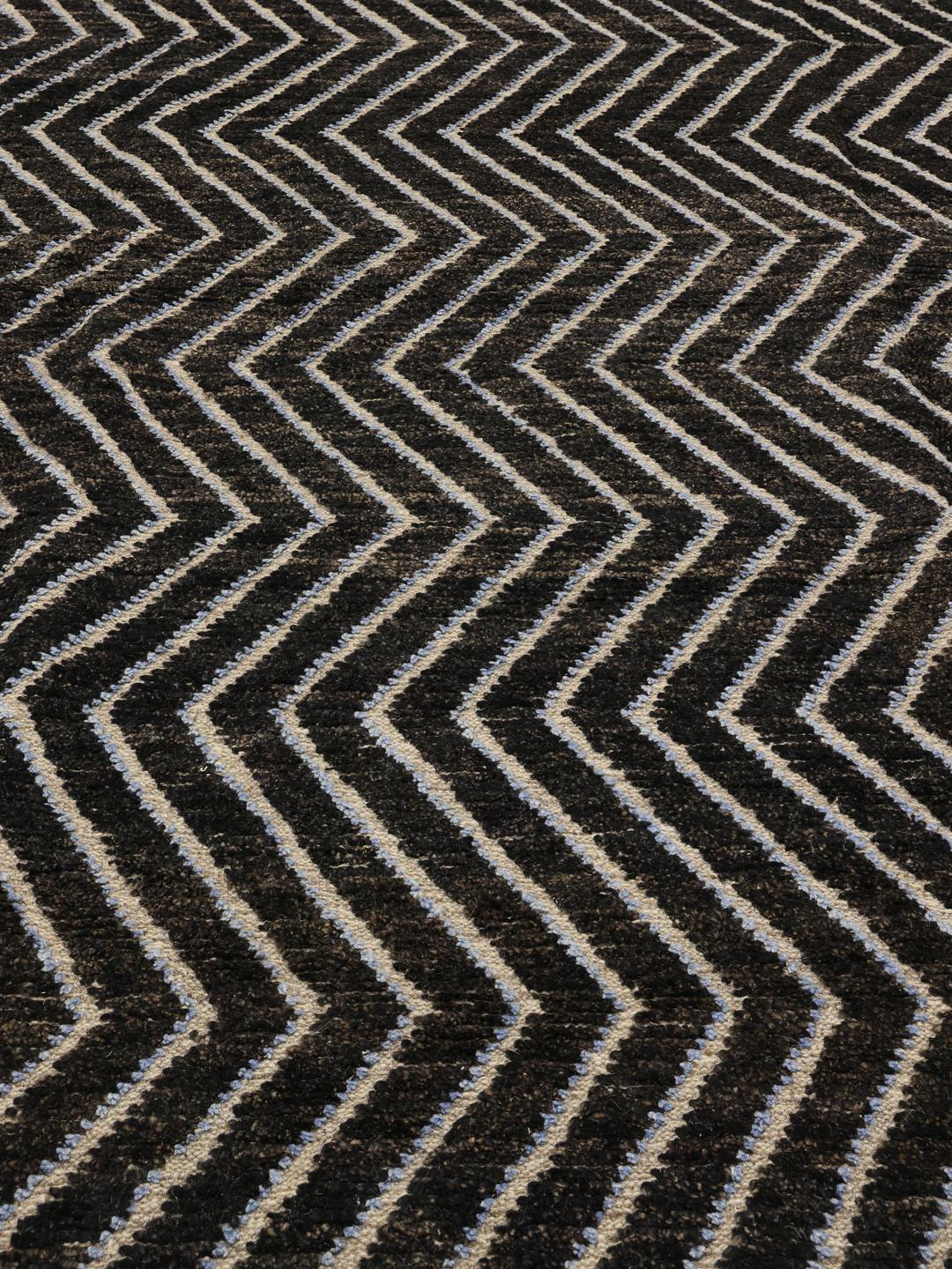 A large hand-knotted rug from Afghanistan with a monochrome zig-zag pattern
