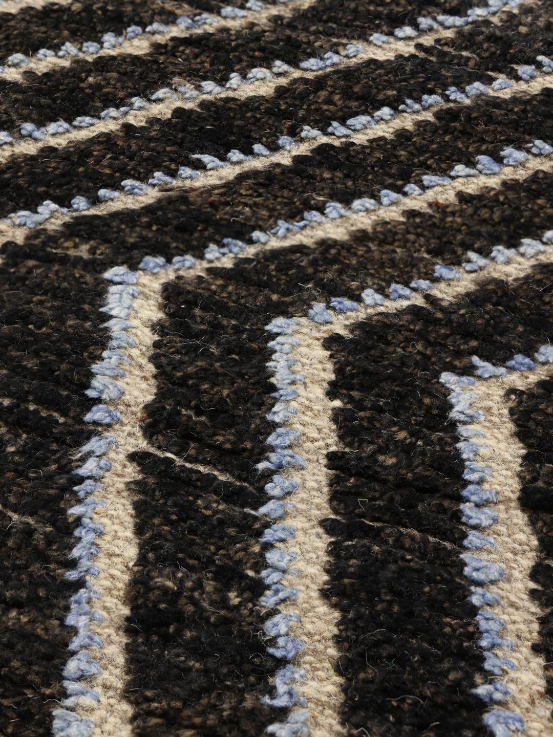 A large hand-knotted rug from Afghanistan with a monochrome zig-zag pattern
