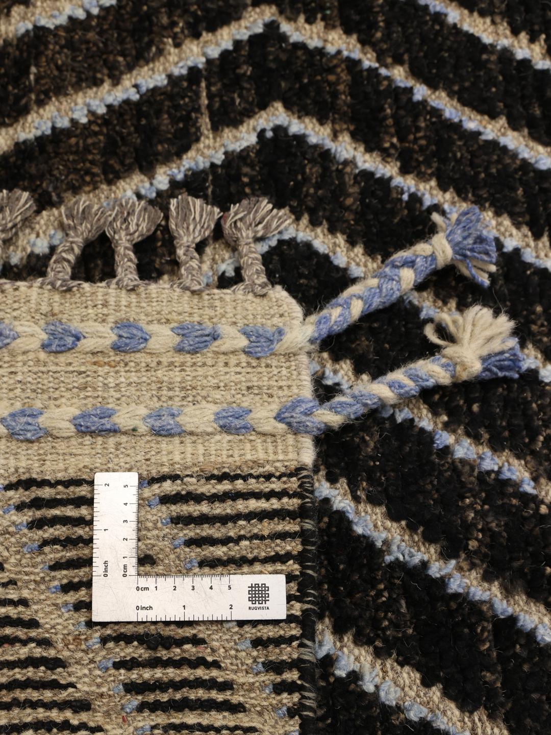 A large hand-knotted rug from Afghanistan with a monochrome zig-zag pattern