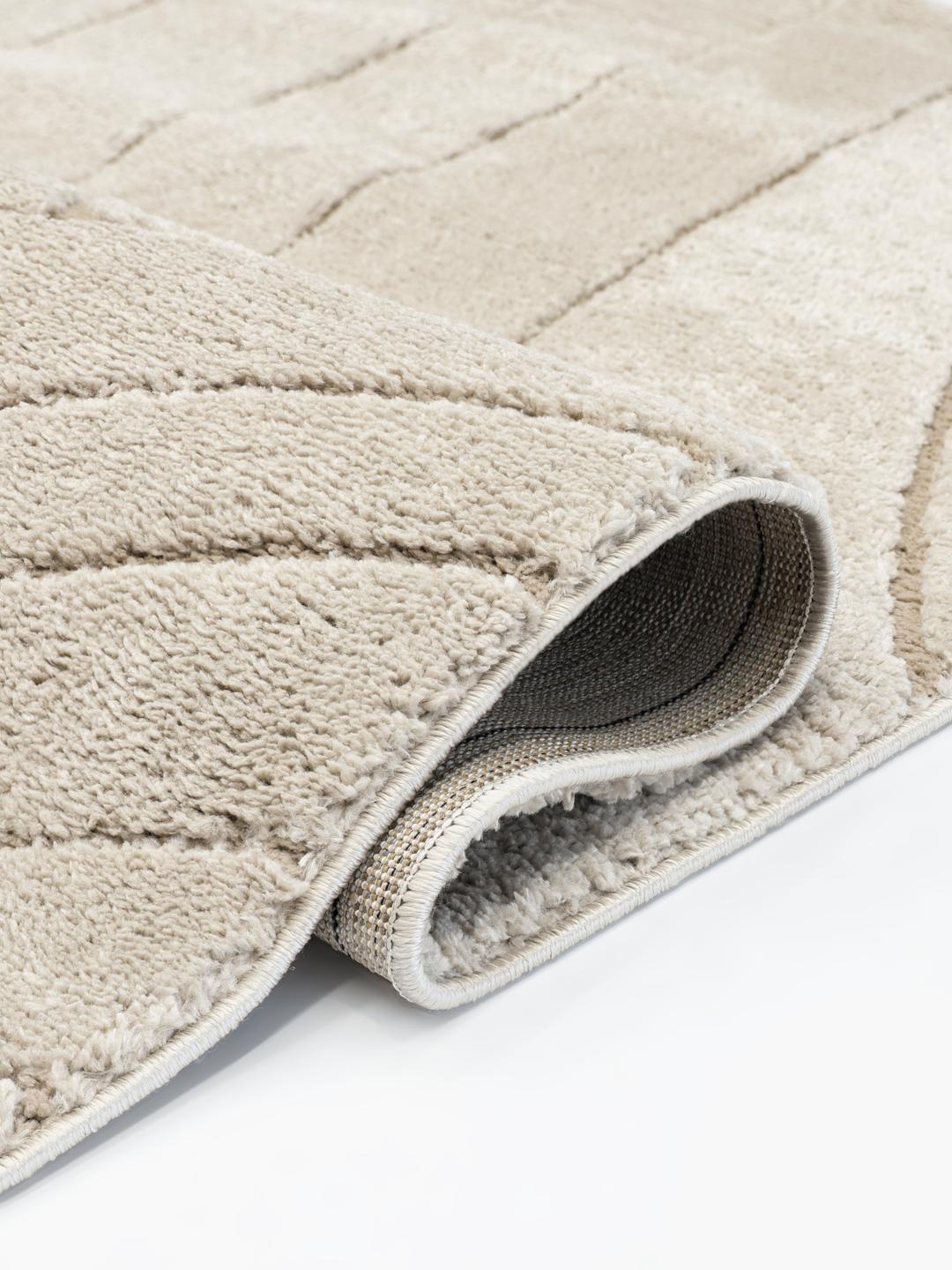 Beige vloerkleed met gebogen ontwerp in hoog en laag pool