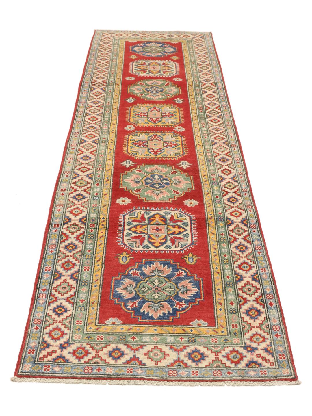 Hand-knotted Afghan runner in vibrant red with geometric patterns
