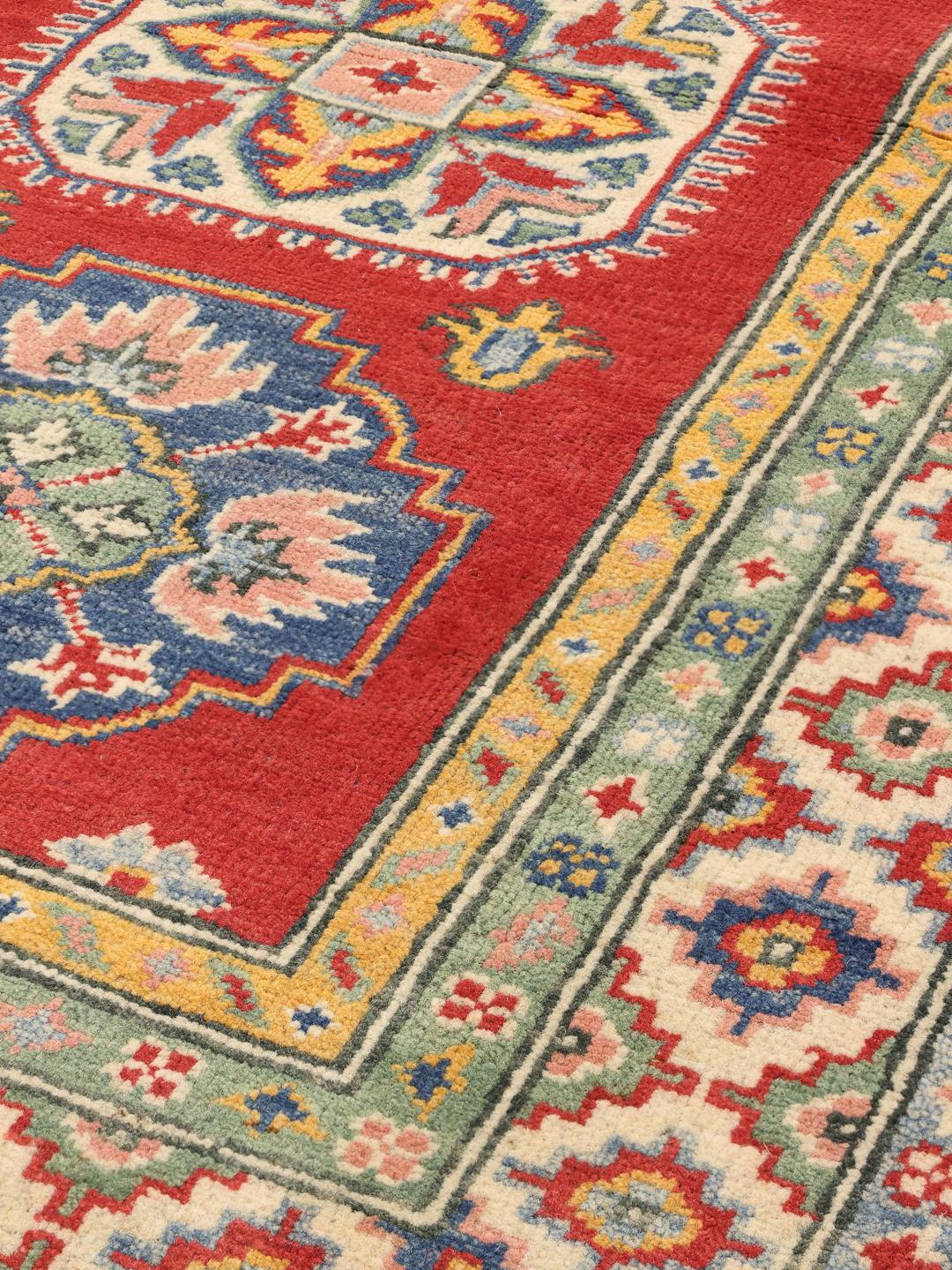 Hand-knotted Afghan runner in vibrant red with geometric patterns
