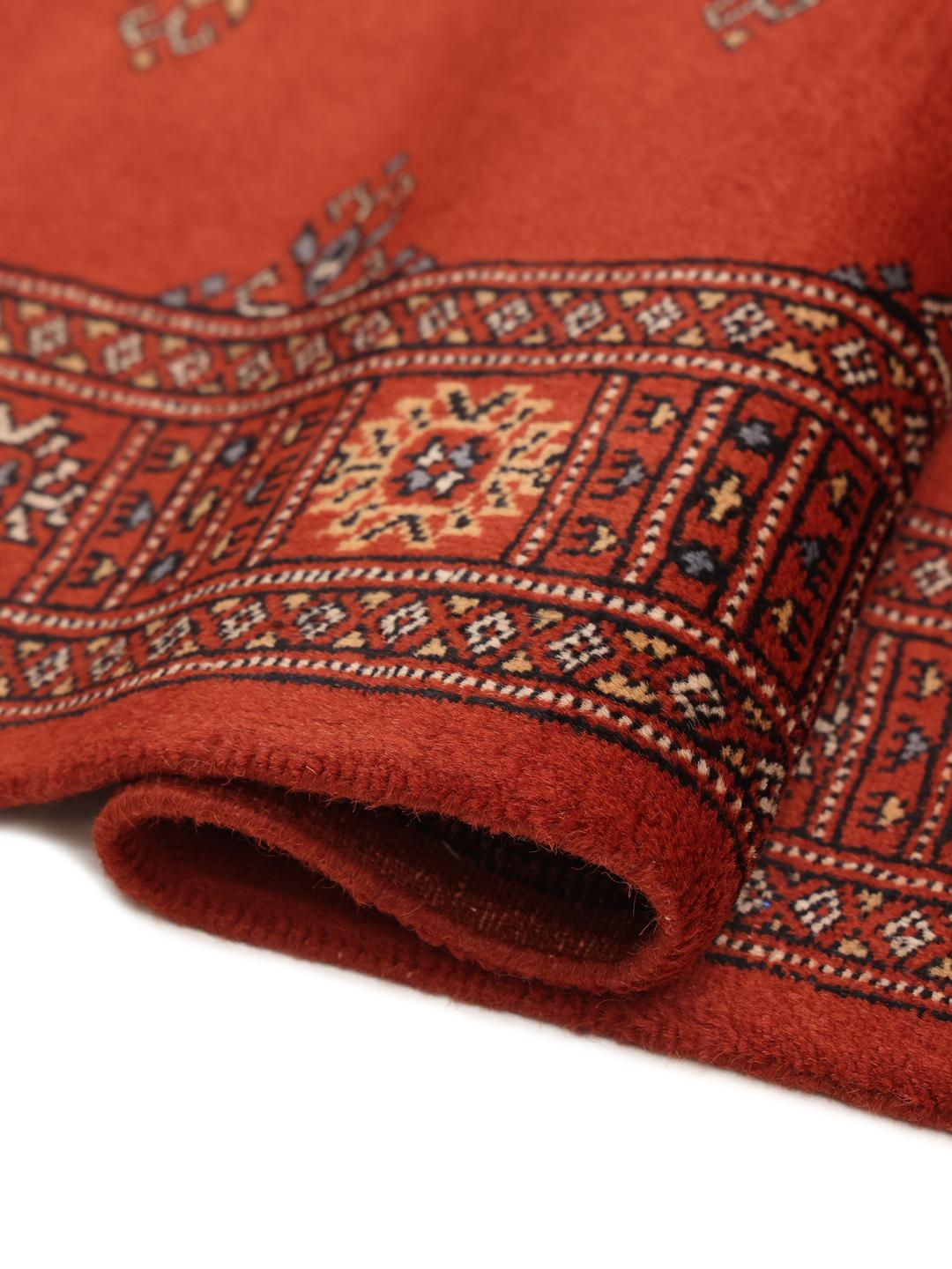 Hand-knotted Pakistan Bokhara runner in deep red with traditional motifs.