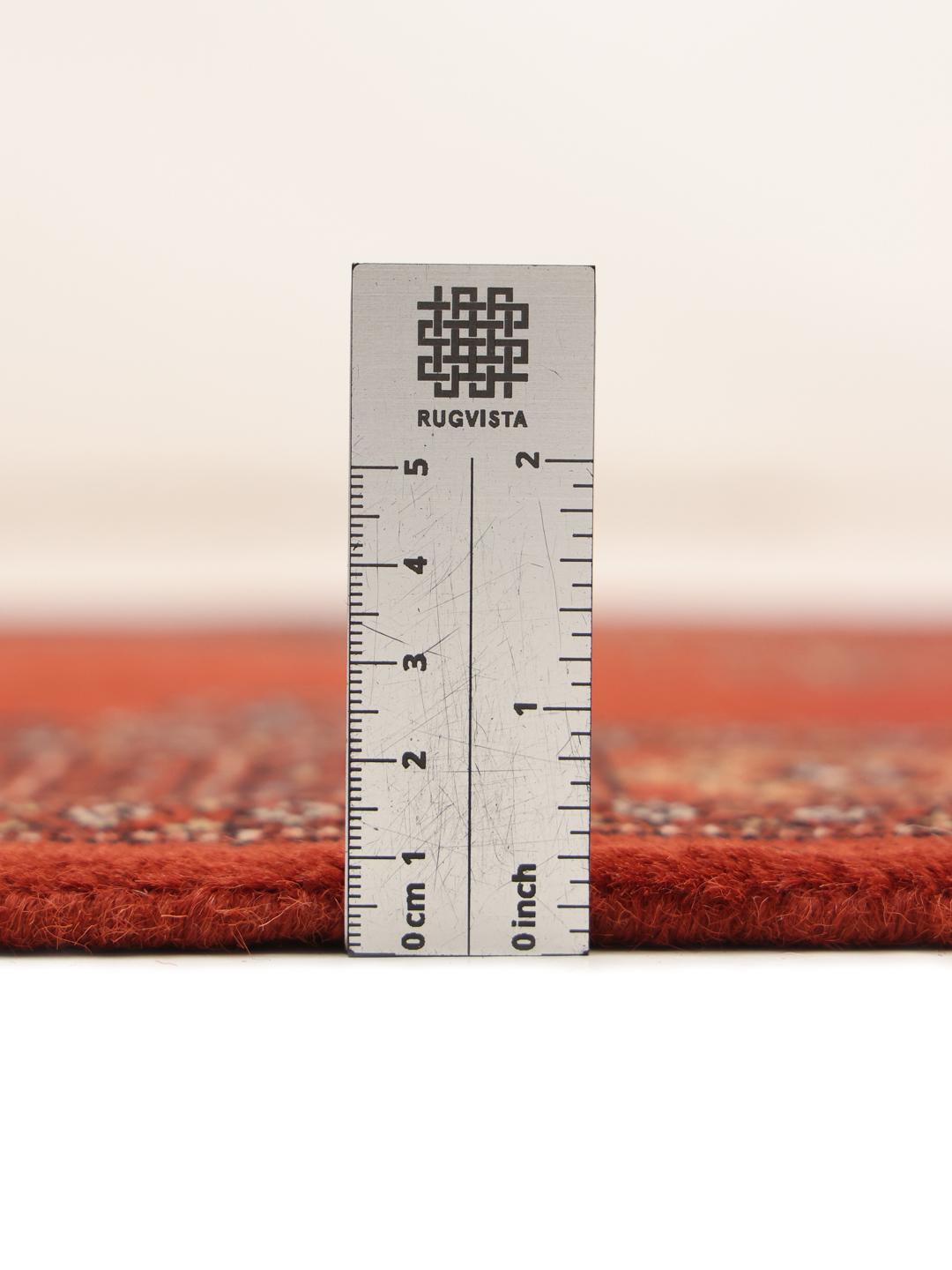 Hand-knotted Pakistan Bokhara runner in deep red with traditional motifs.