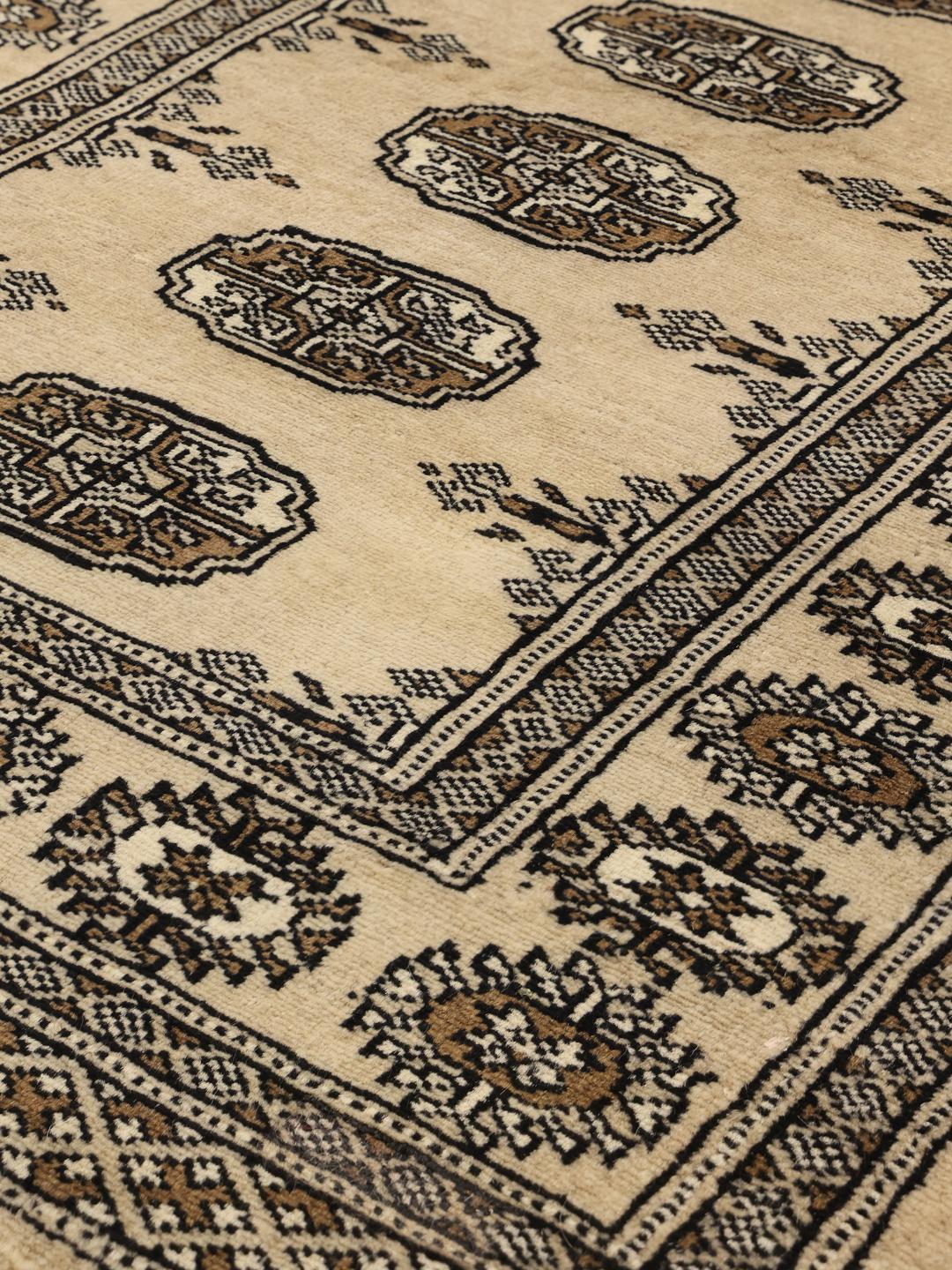 Hand-knotted Pakistani runner rug in beige with repeating motifs