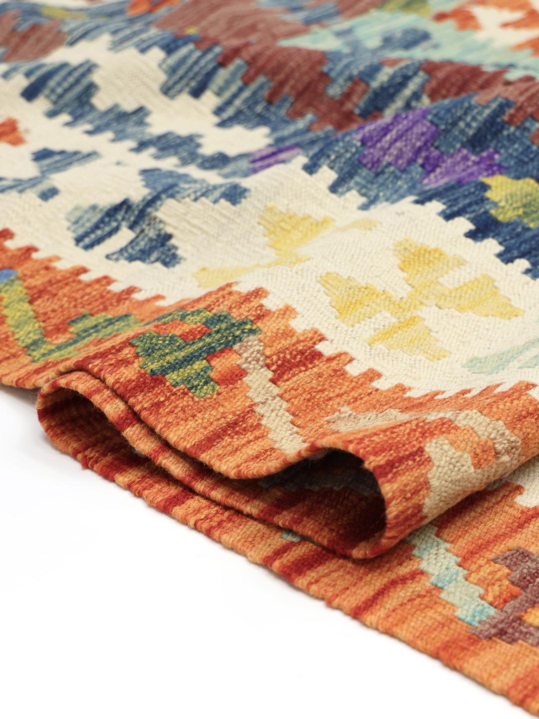 A large, hand-woven Afghan Kelim rug featuring a vibrant geometric pattern in multicolor tones.