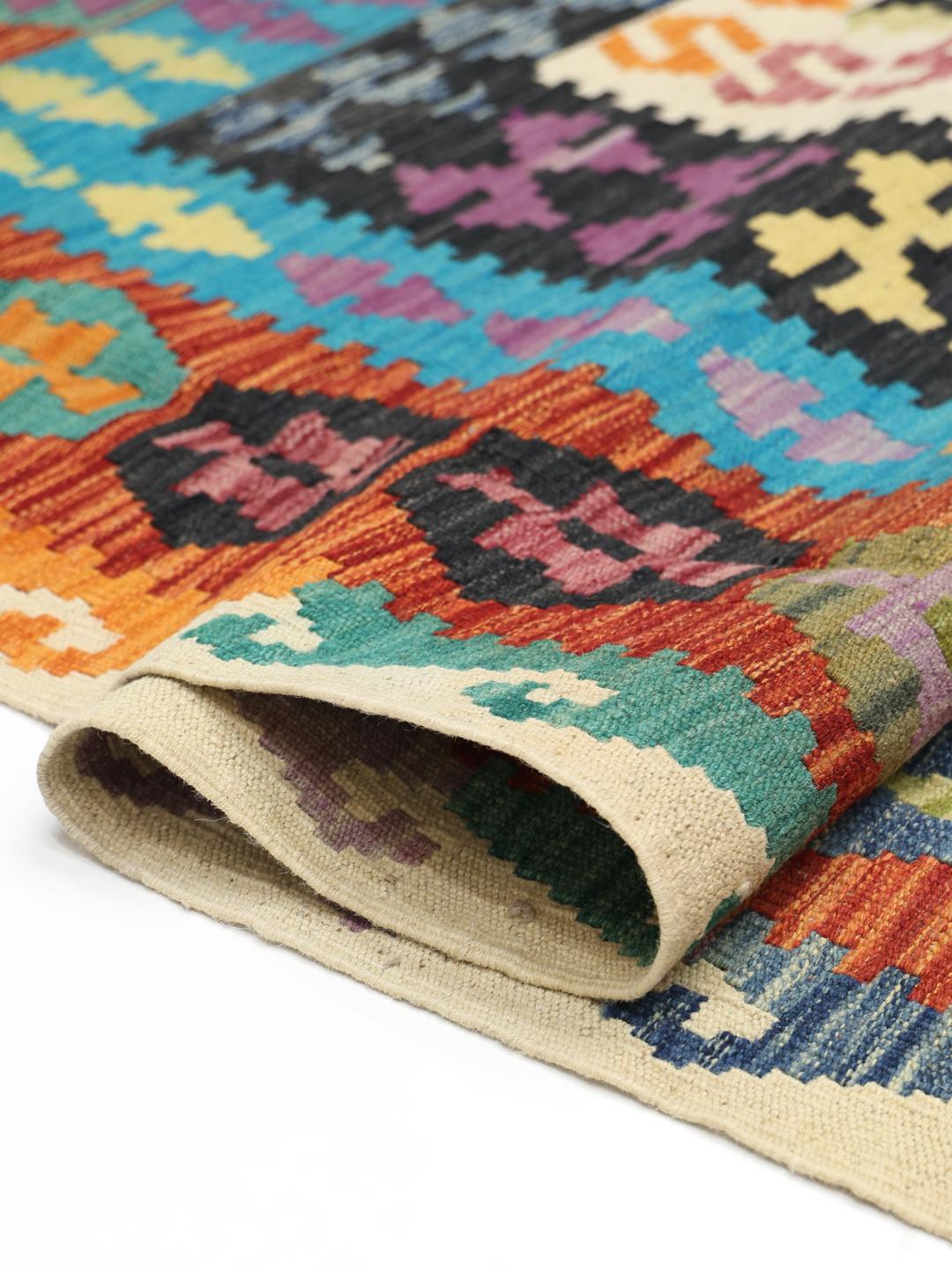 Hand-woven Afghan Kelim rug with vibrant geometric patterns and a multicolor palette
