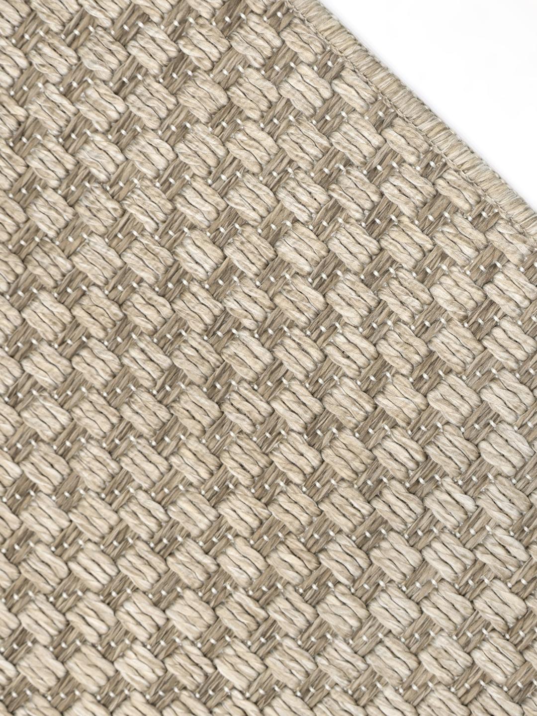 Beige vloerkleed met een gestructureerd patroon