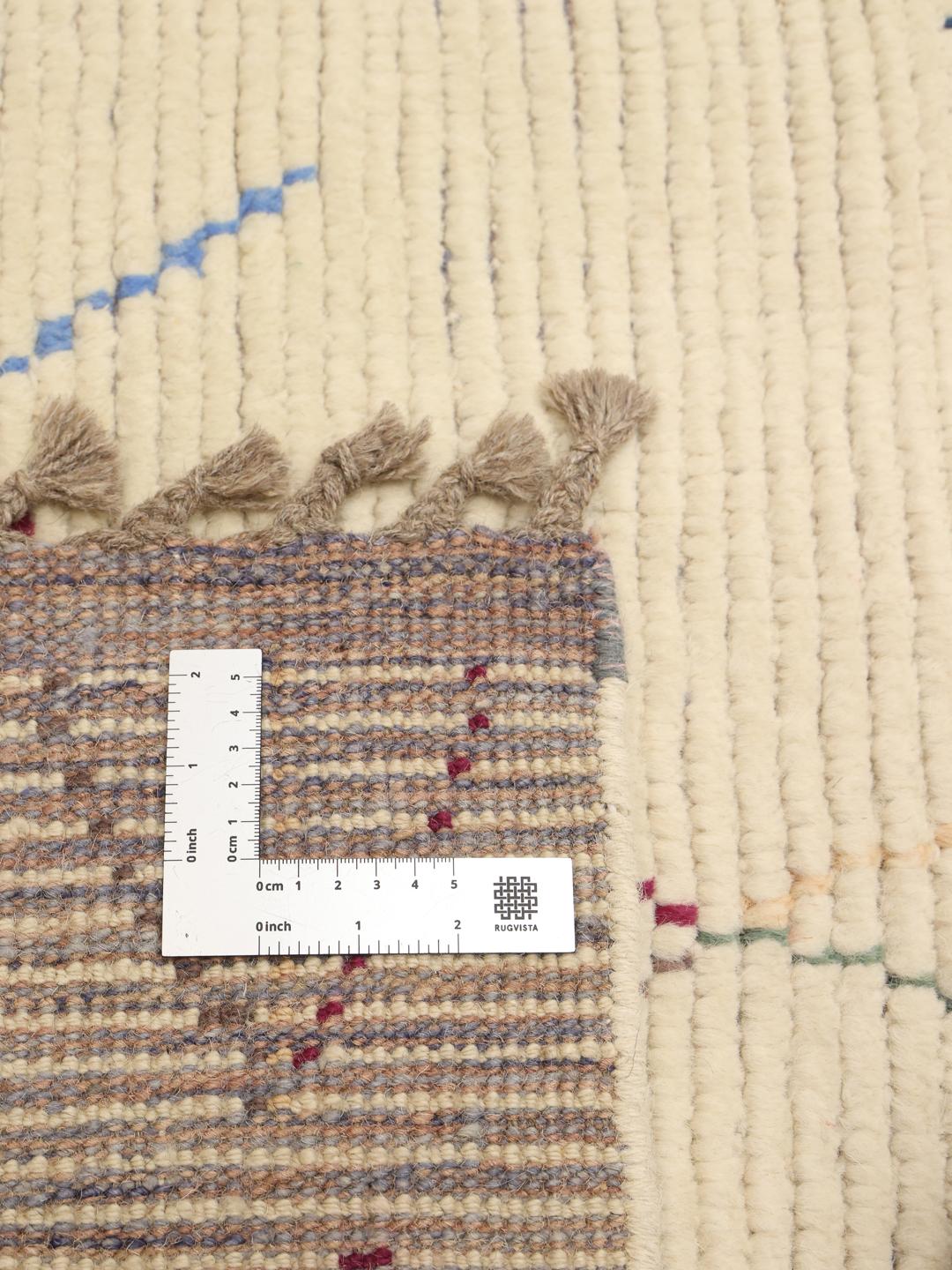 Hand-knotted Afghan rug with colourful geometric motifs on a beige background