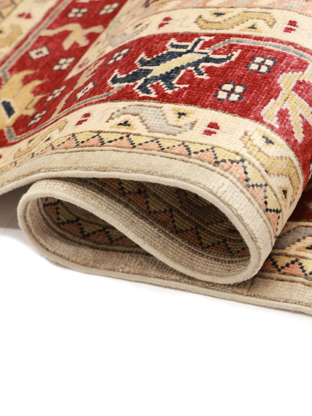 Tapis Kazak noué main originaire d'Afghanistan dans des tons beige et rouge.