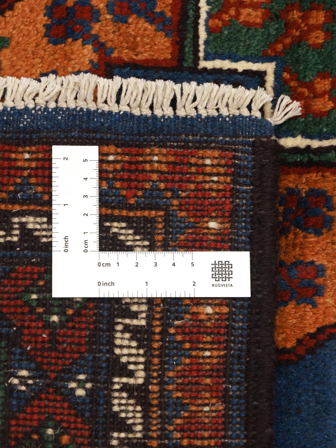 Handgeknoopt Afghan tapijt met een blauw veld en traditionele motieven
