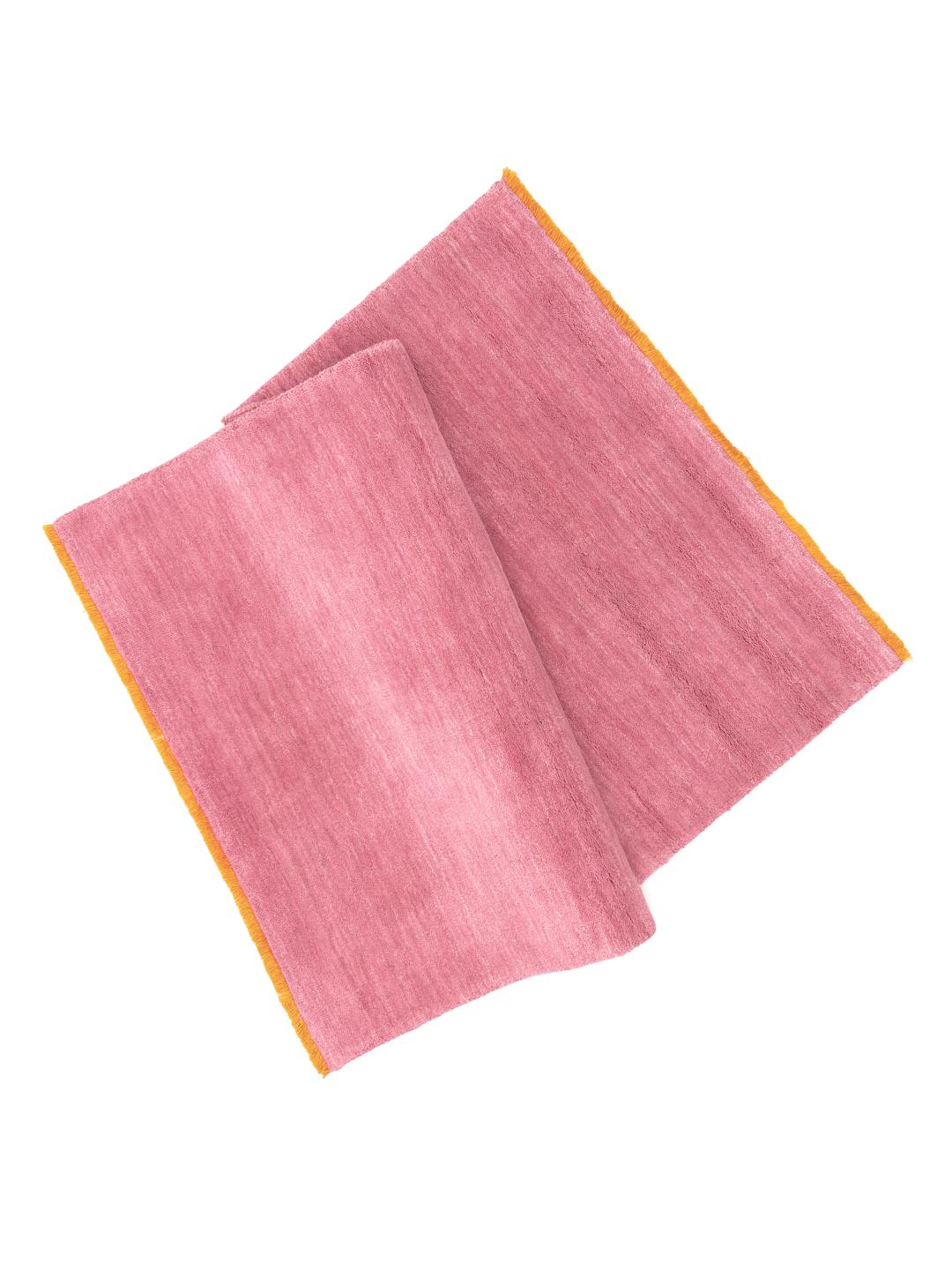 A pink and orange Wool rug with a soft texture.