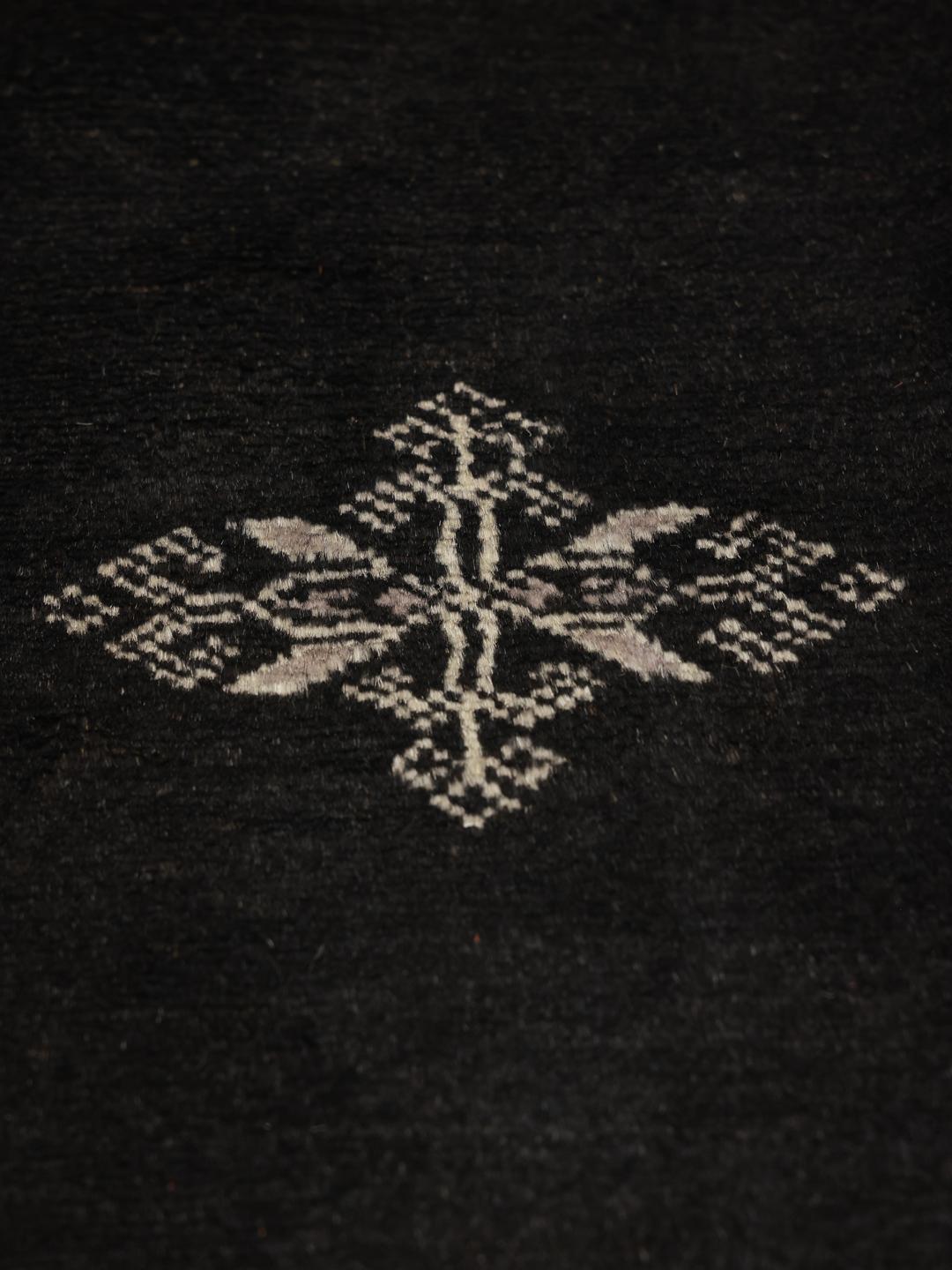 Hand-knotted Pakistani rug in black with repeating geometric motifs