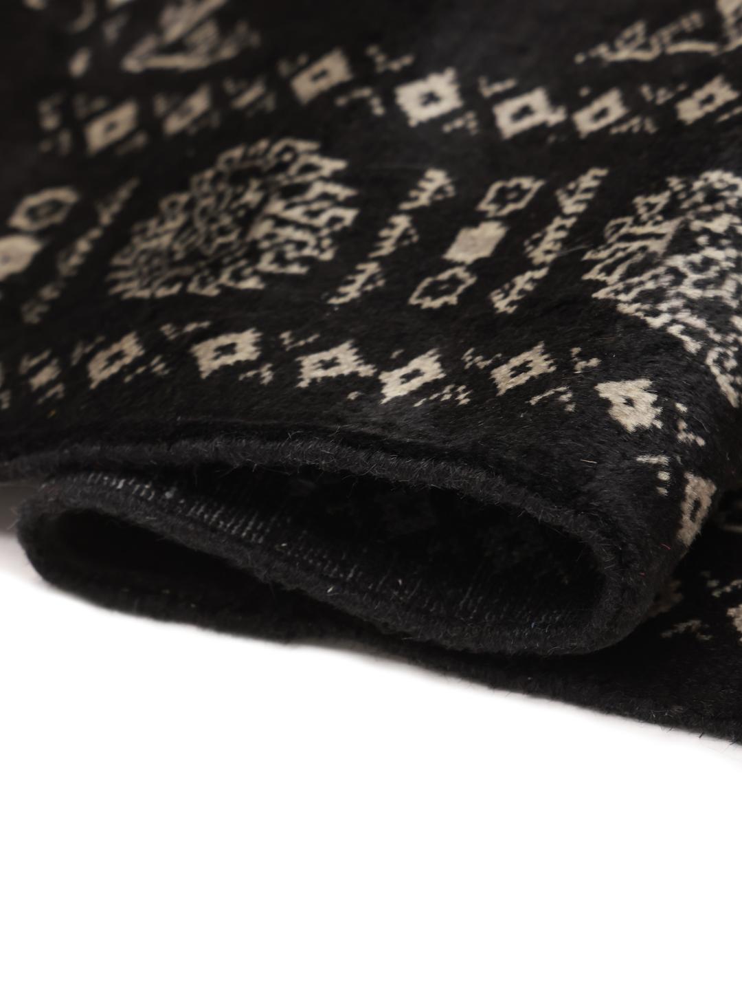 Hand-knotted Pakistani rug in black with repeating geometric motifs