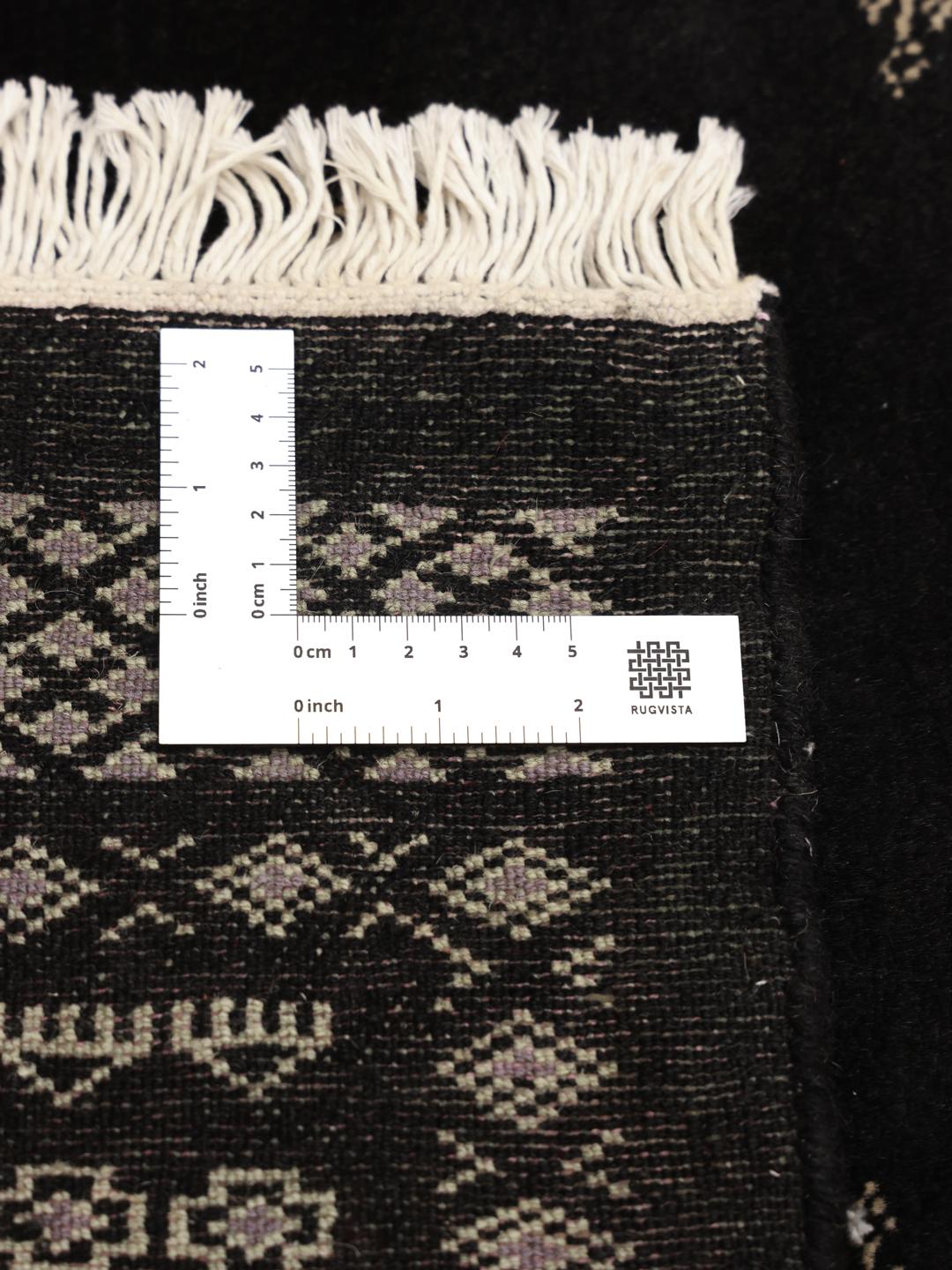 Hand-knotted Pakistani rug in black with repeating geometric motifs