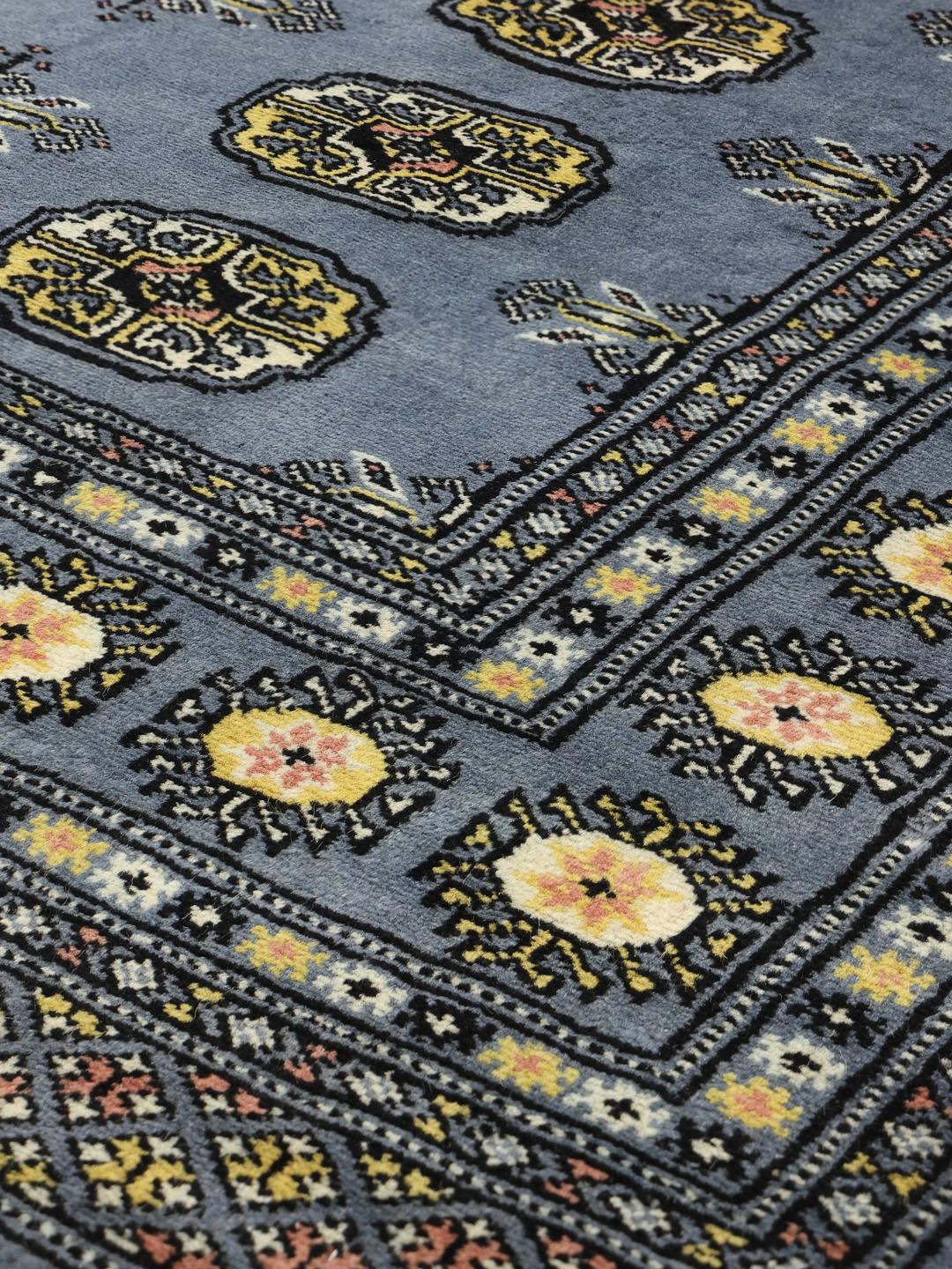 Hand-knotted Pakistan Bokhara 2ply rug in blue with traditional geometric motifs.