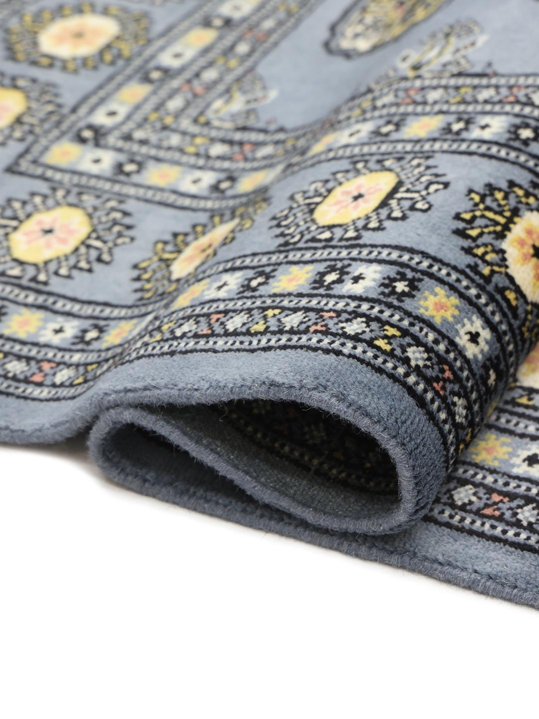 Hand-knotted Pakistan Bokhara 2ply rug in blue with traditional geometric motifs.