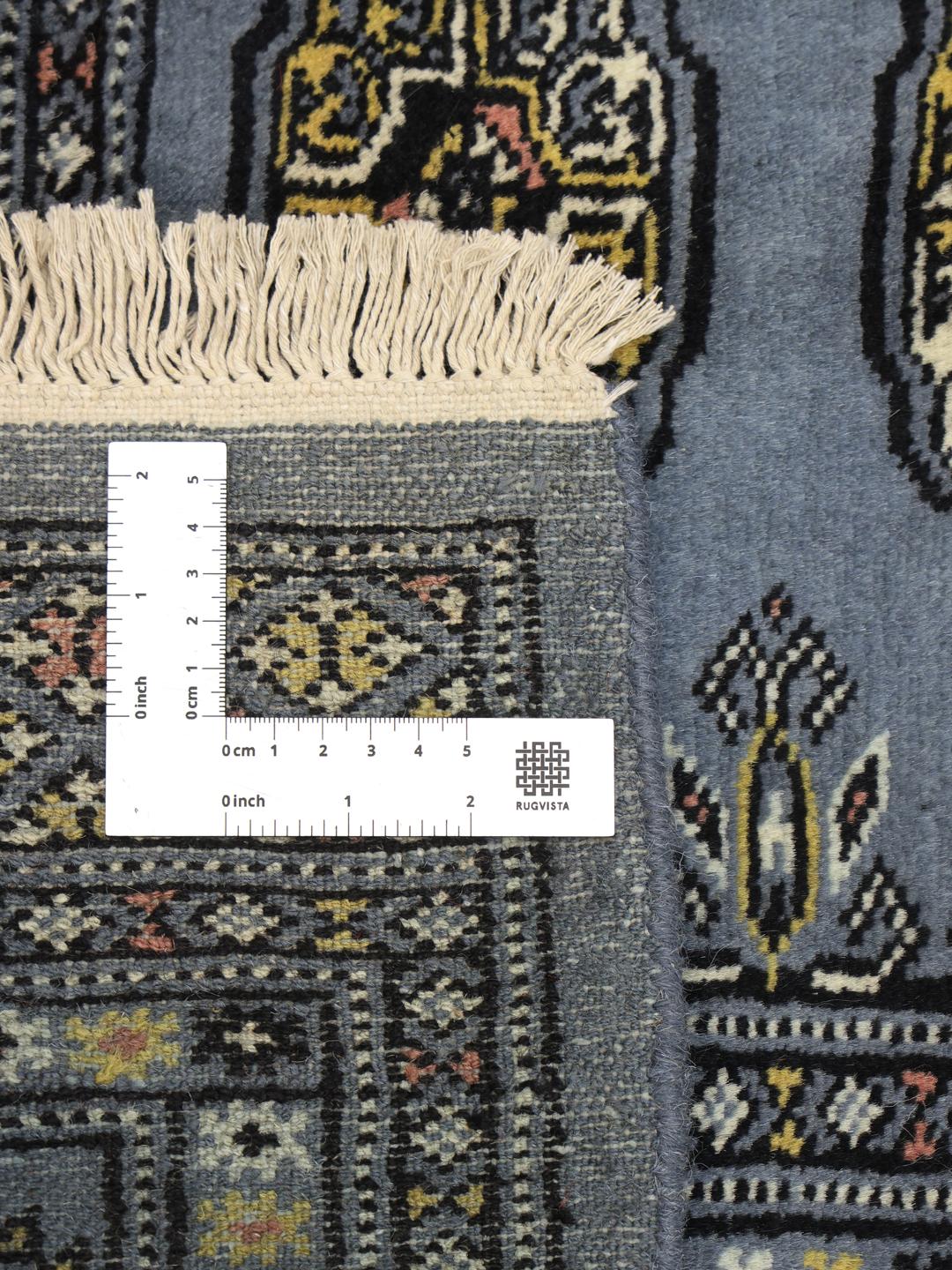 Hand-knotted Pakistan Bokhara 2ply rug in blue with traditional geometric motifs.