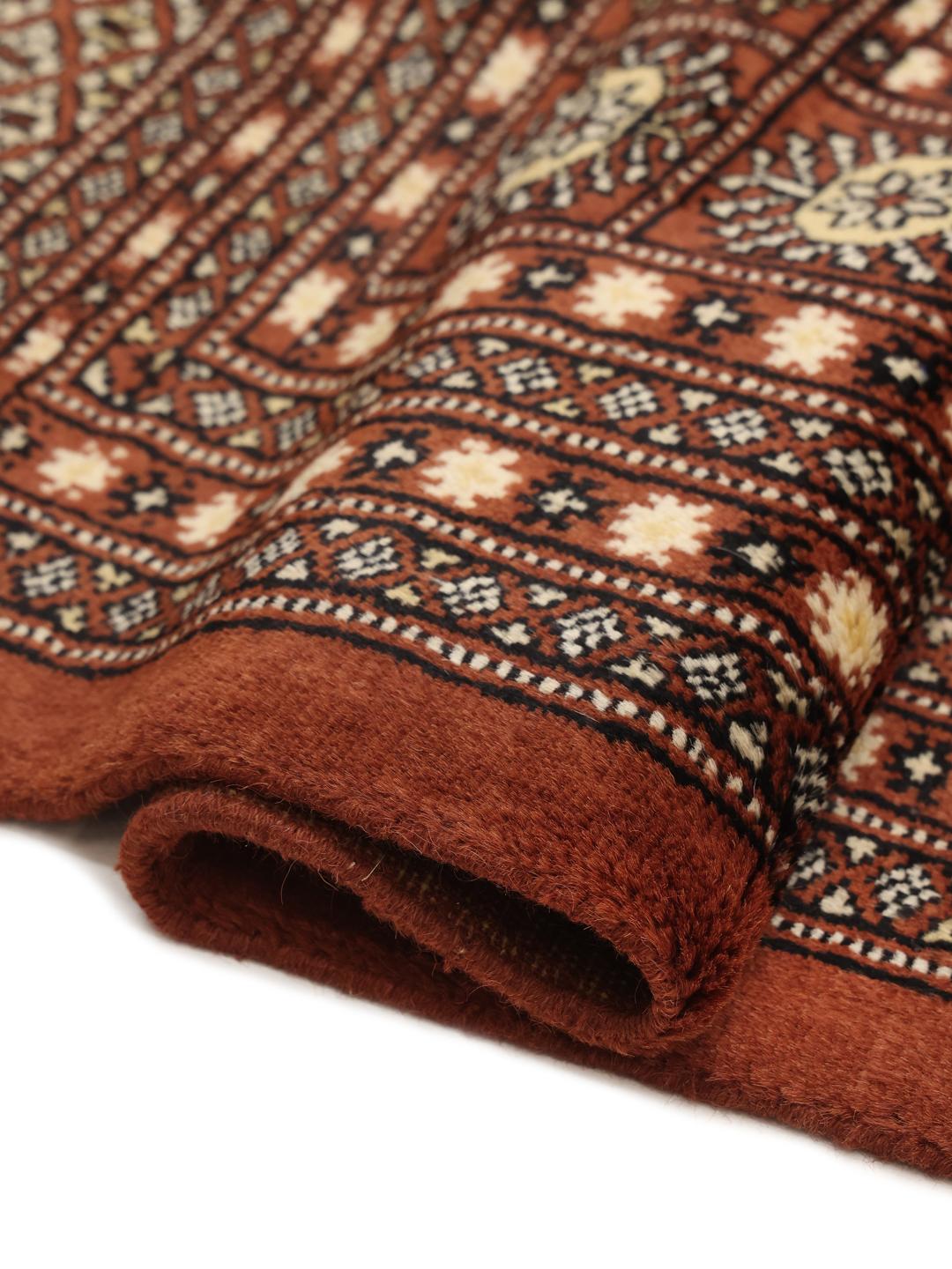 Hand-knotted Pakistani Bokhara rug in dark-red with traditional gul motifs
