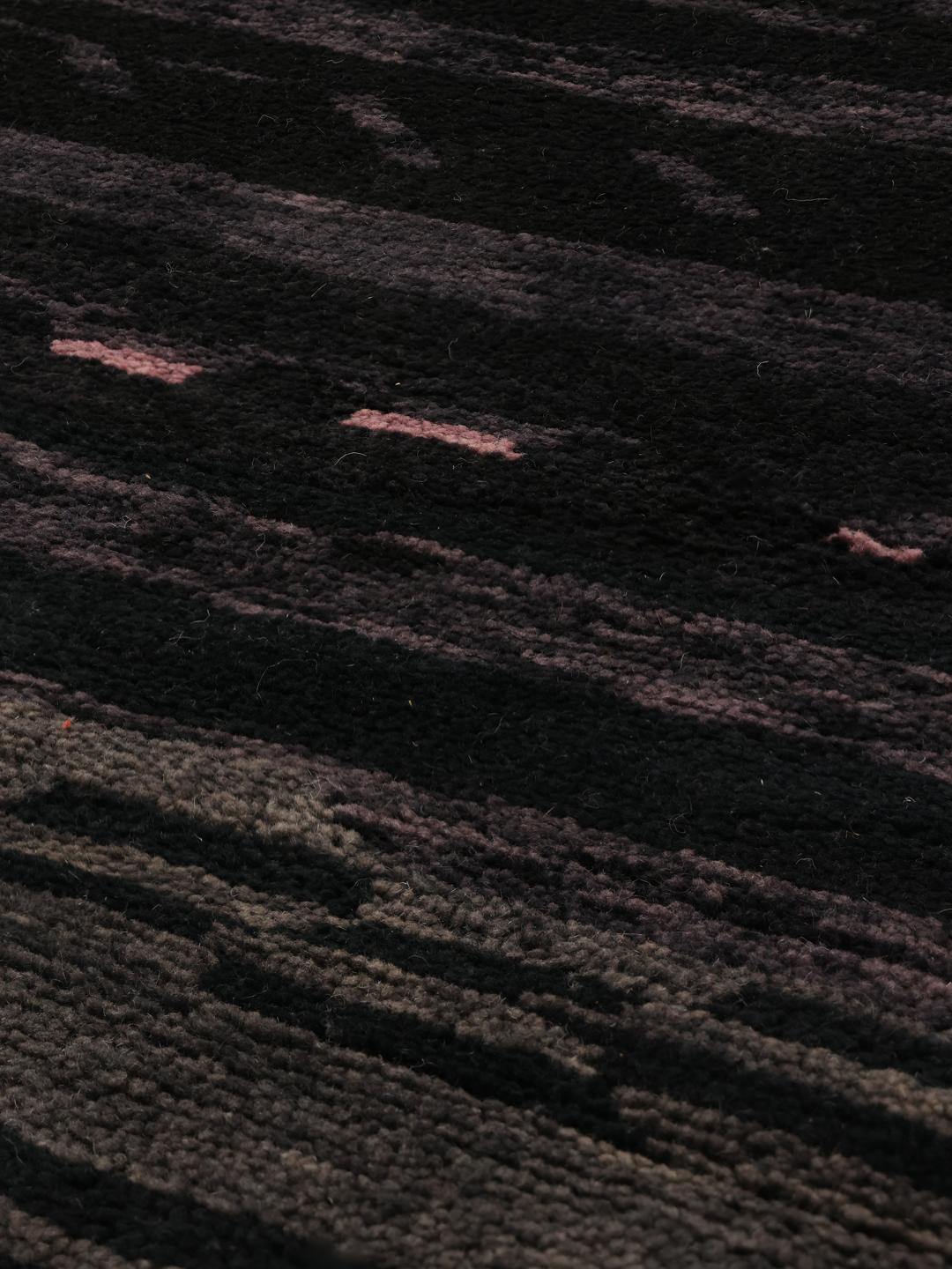 Hand-knotted black Berber Moroccan rug from Morocco featuring subtle horizontal accents.