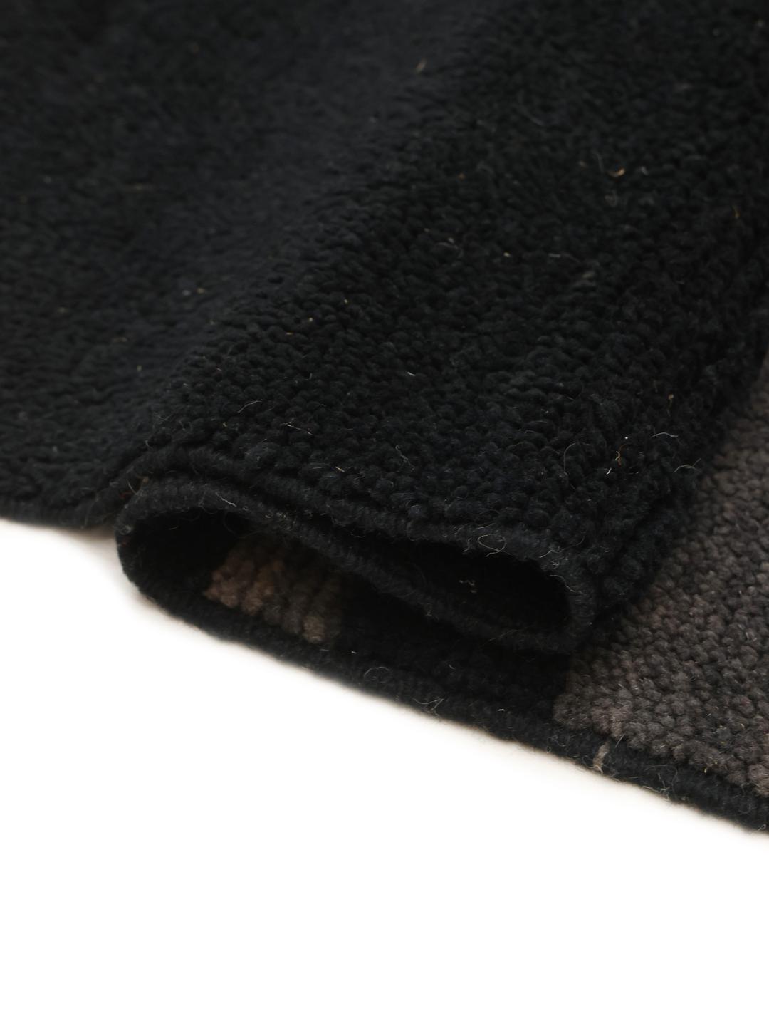 Hand-knotted black Berber Moroccan rug from Morocco featuring subtle horizontal accents.